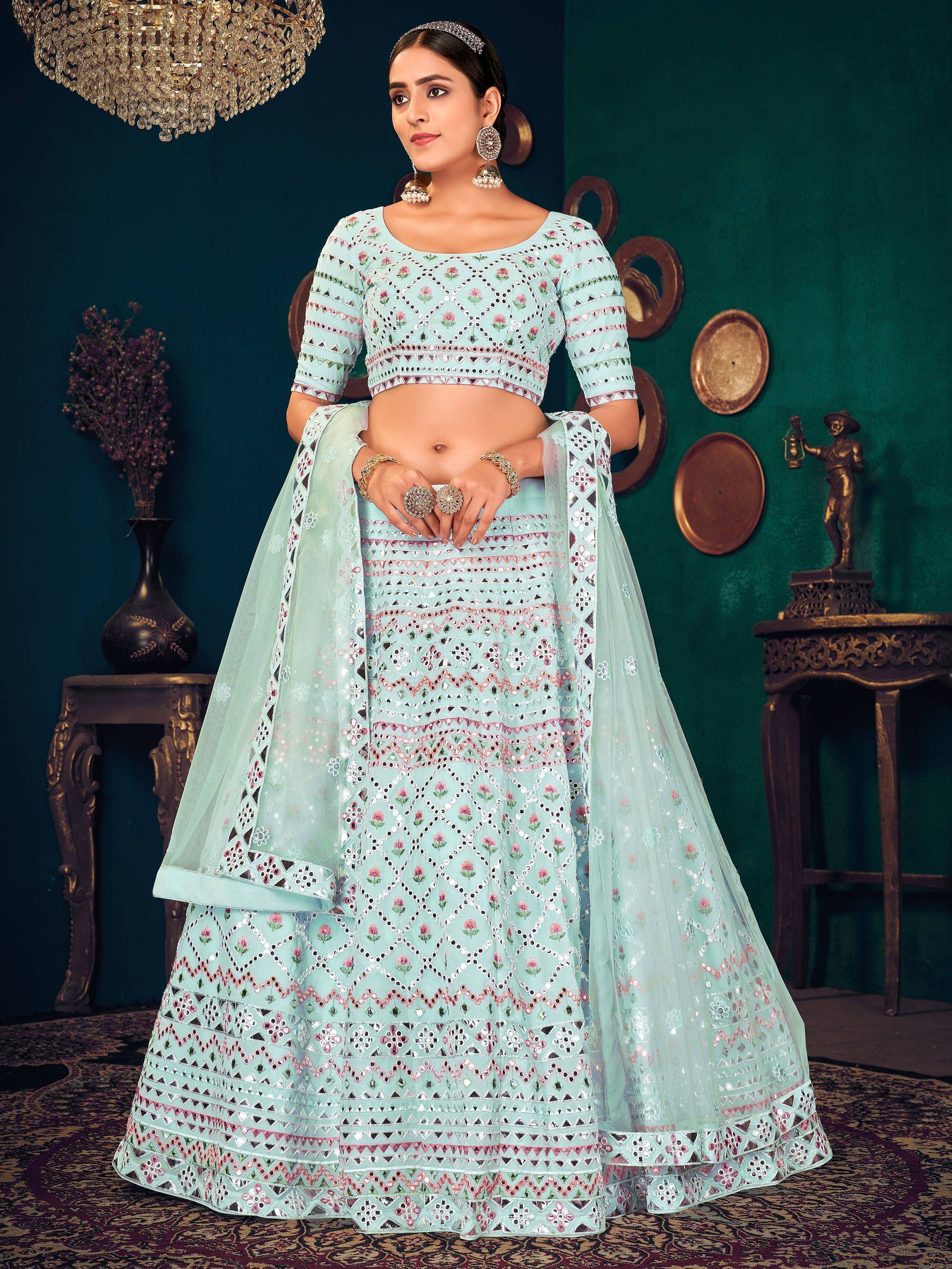 Mint green designer lehenga choli with mirror work and floral embroidery, perfect for Indian weddings and festive occasions.