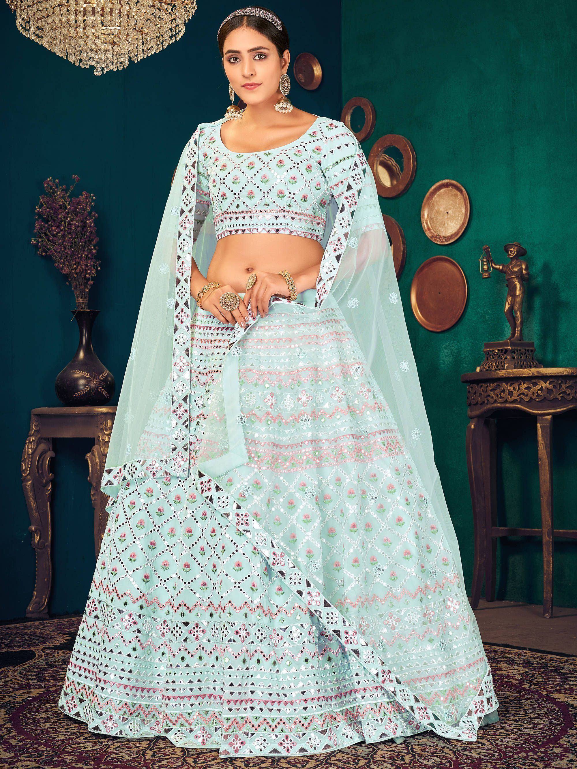 Mint green designer lehenga choli with floral mirror work and sheer dupatta, perfect for Indian ethnic occasions.