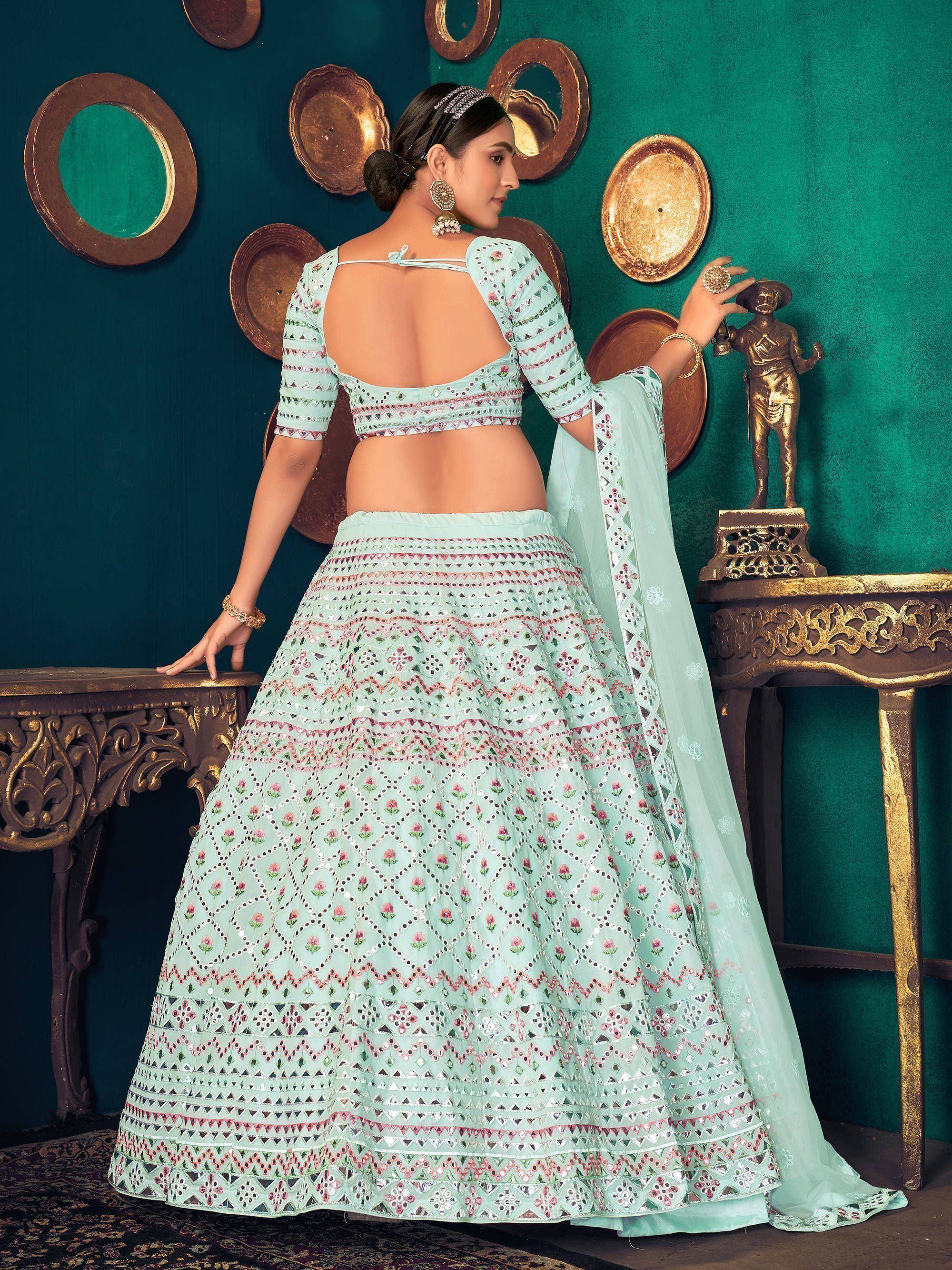 Mint green designer lehenga choli with mirror work and floral embroidery, perfect for Indian ethnic occasions.