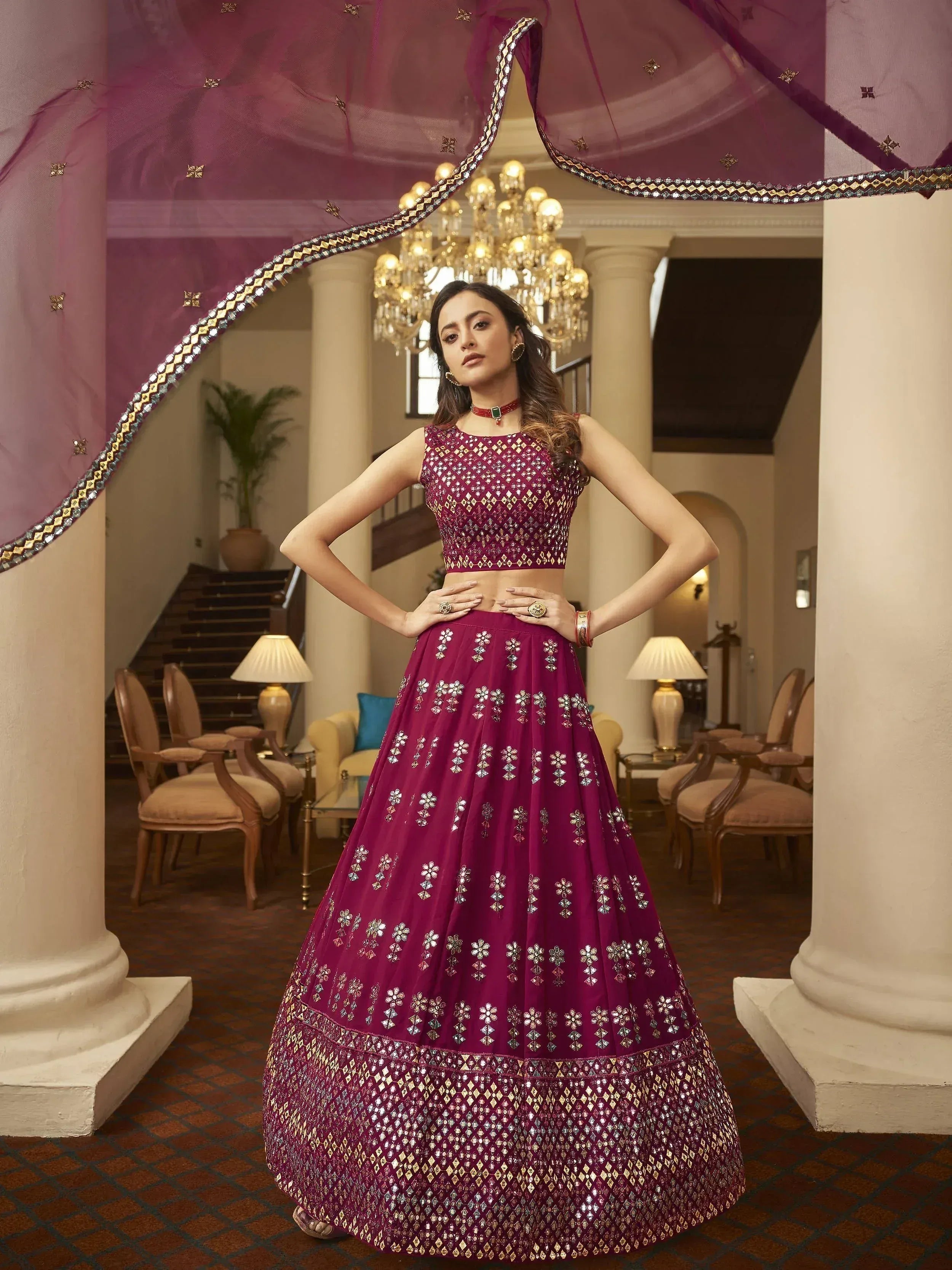Elegant maroon lehenga choli with intricate mirror work, perfect for Indian weddings and festive occasions.