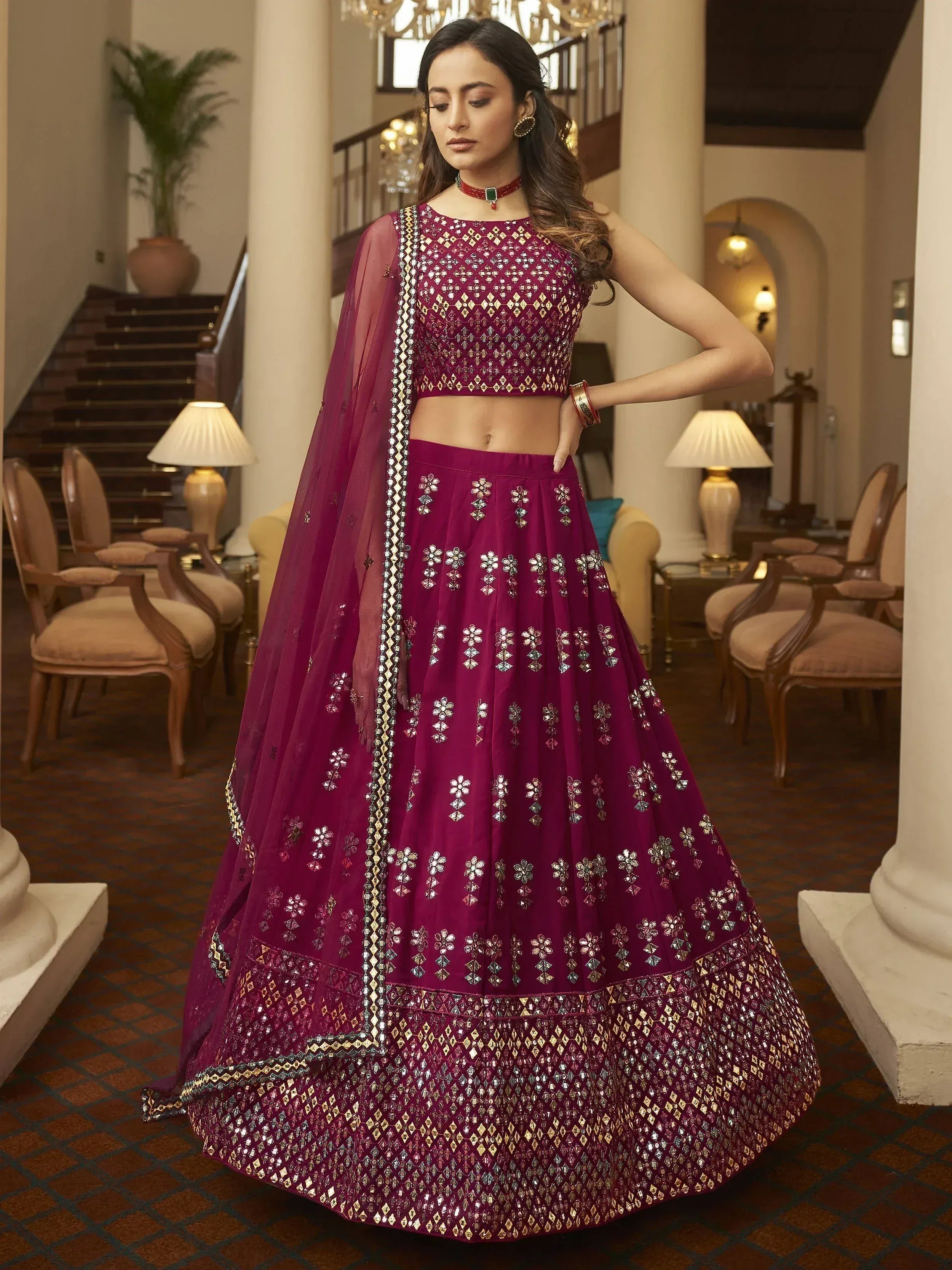 Elegant maroon lehenga choli with mirror work and gold embroidery, perfect for Indian ethnic wear occasions