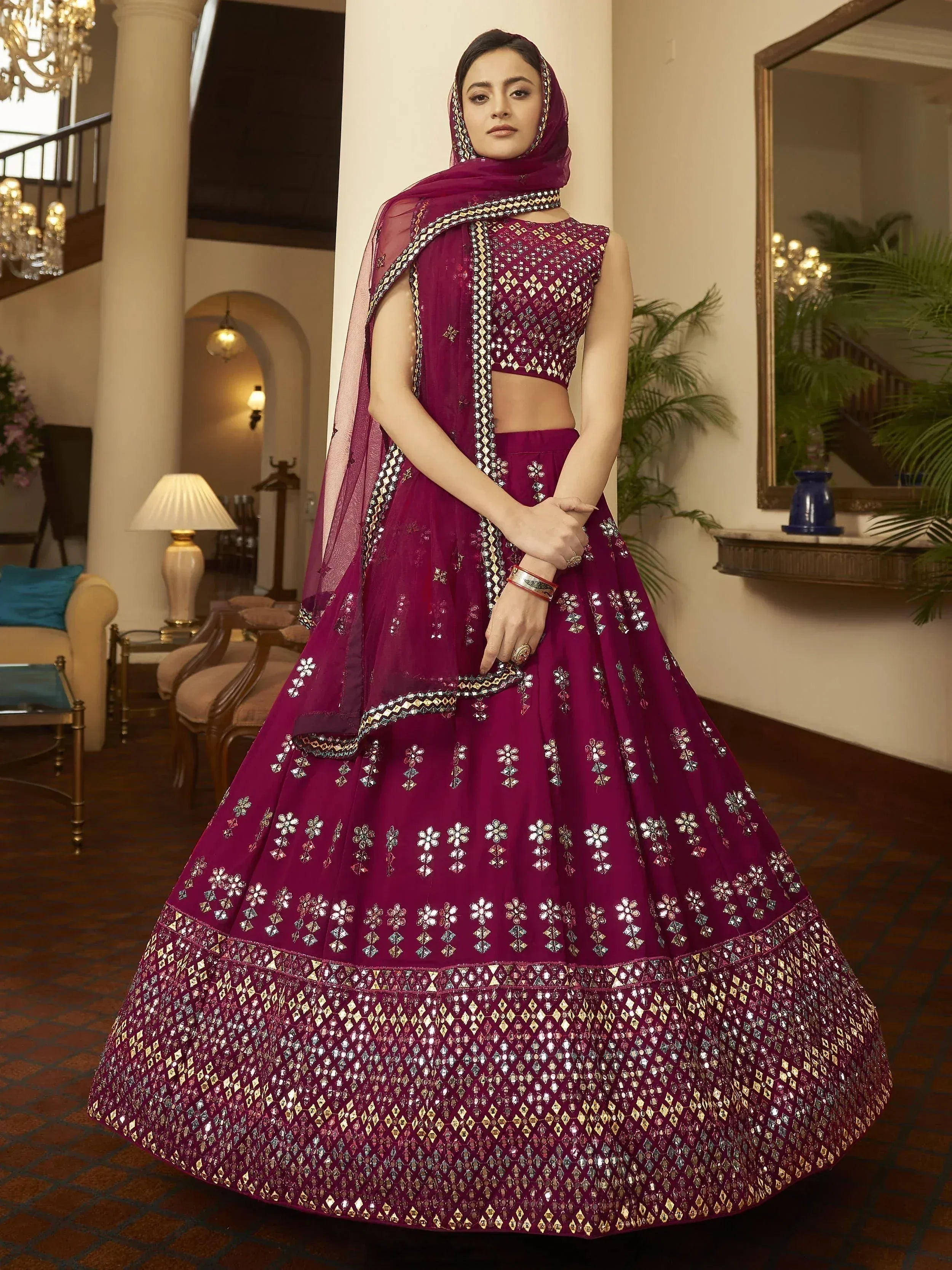 Purple designer lehenga choli with mirror work, perfect for Indian weddings and festive occasions.