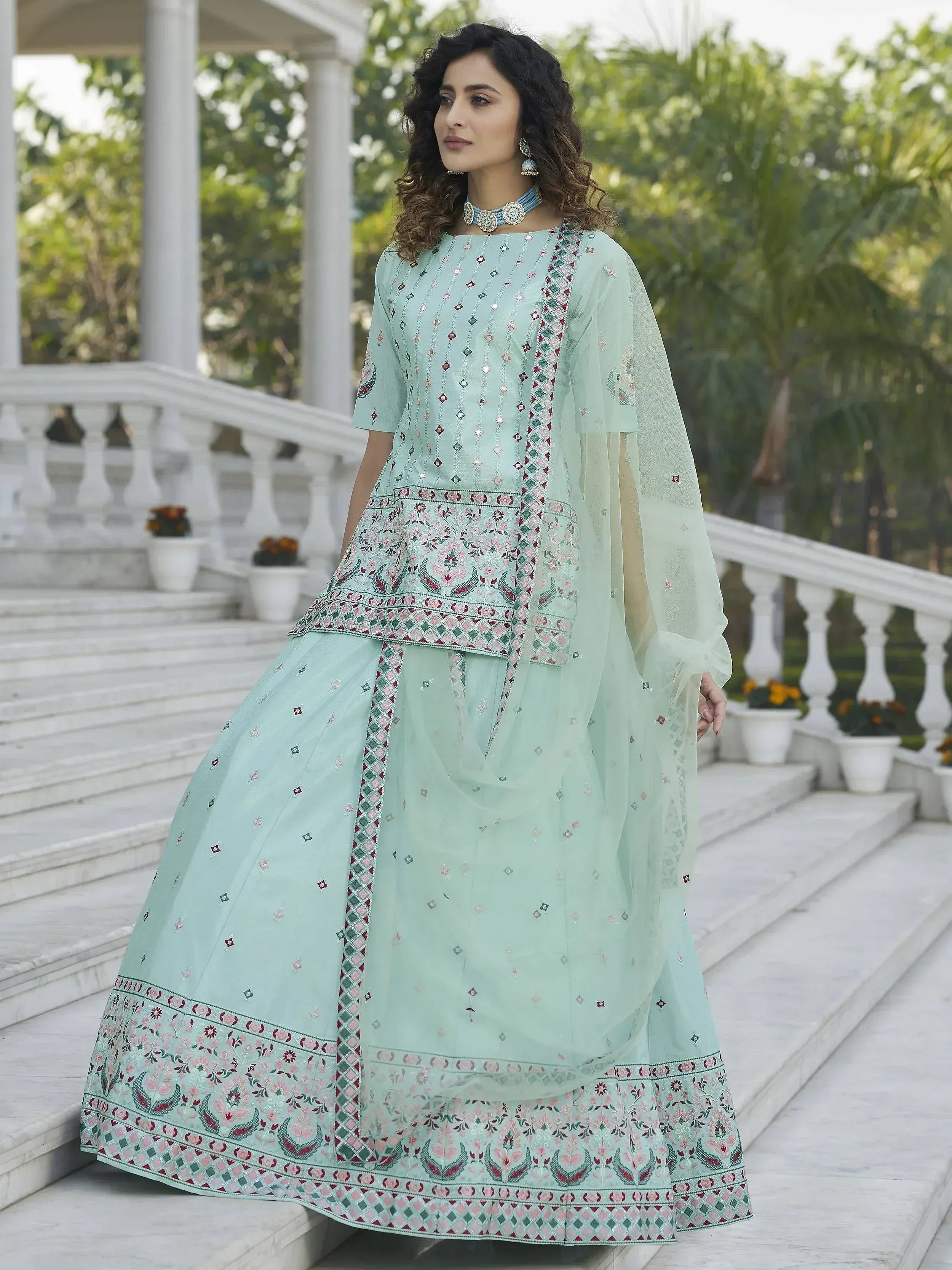 Mint green embroidered lehenga choli with floral patterns, perfect for Indian ethnic occasions.