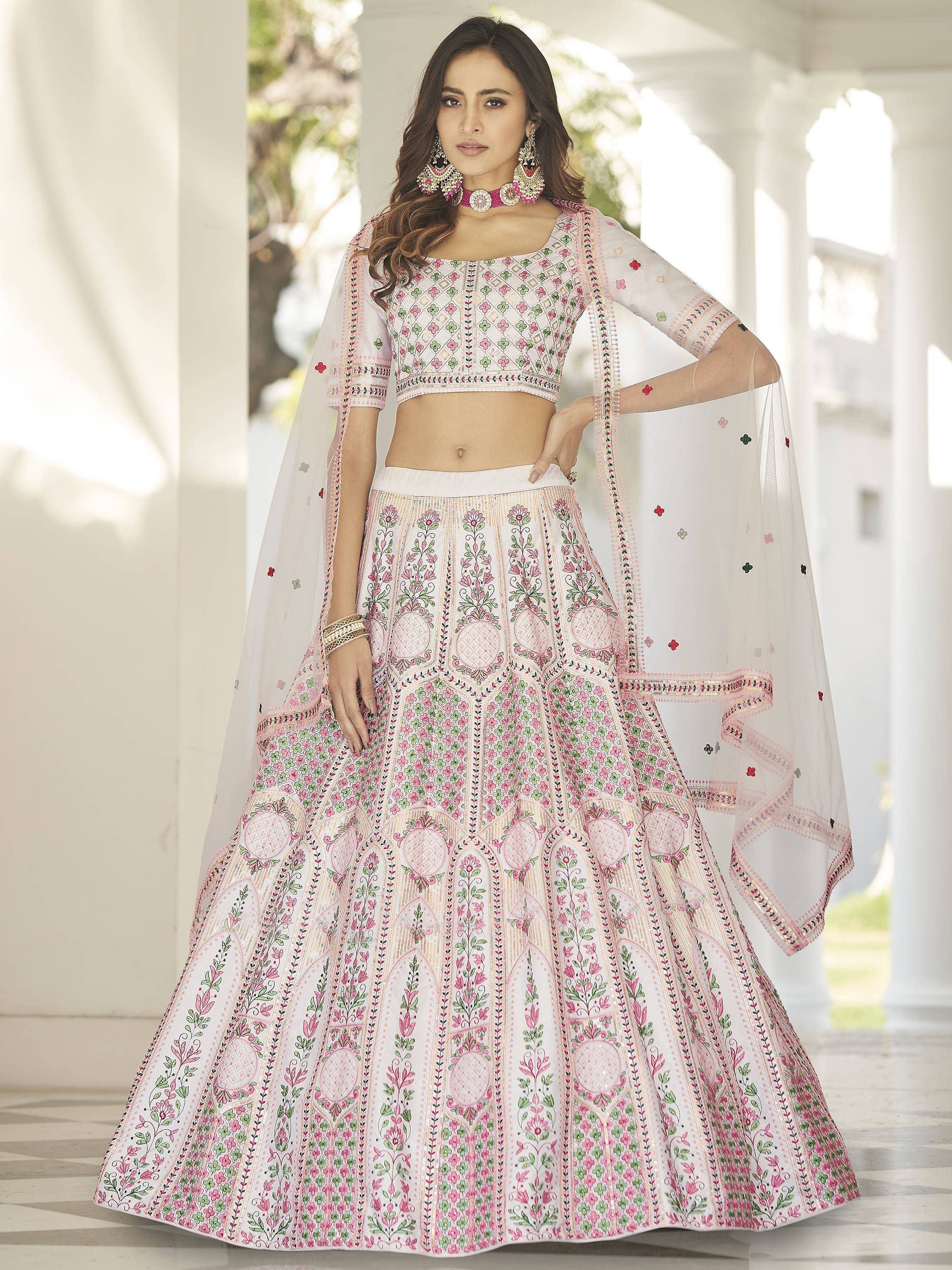 White and pink embroidered lehenga choli with floral patterns, perfect for Indian ethnic wear occasions