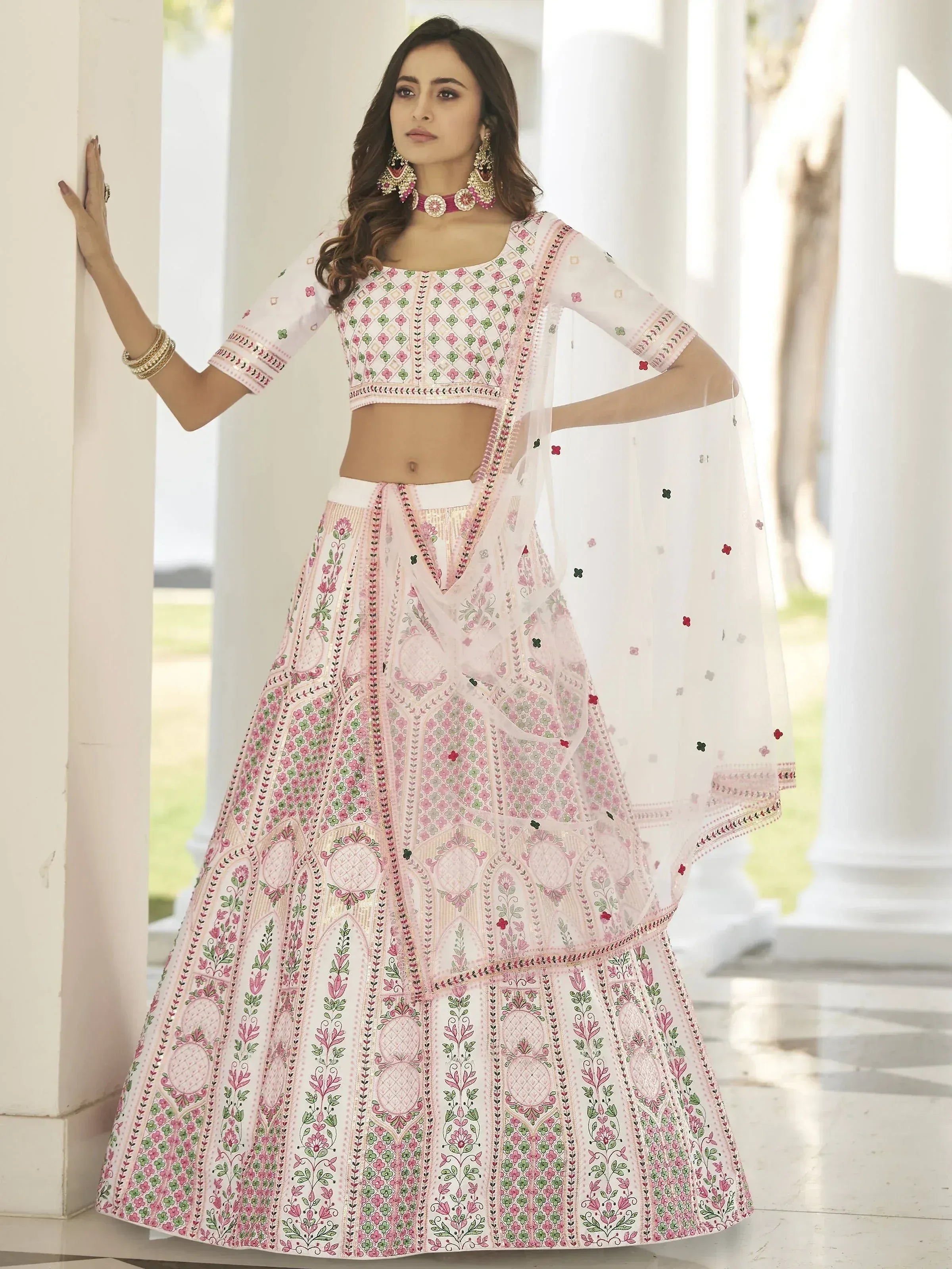 Elegant white and pink embroidered lehenga choli with floral patterns, perfect for Indian ethnic occasions.
