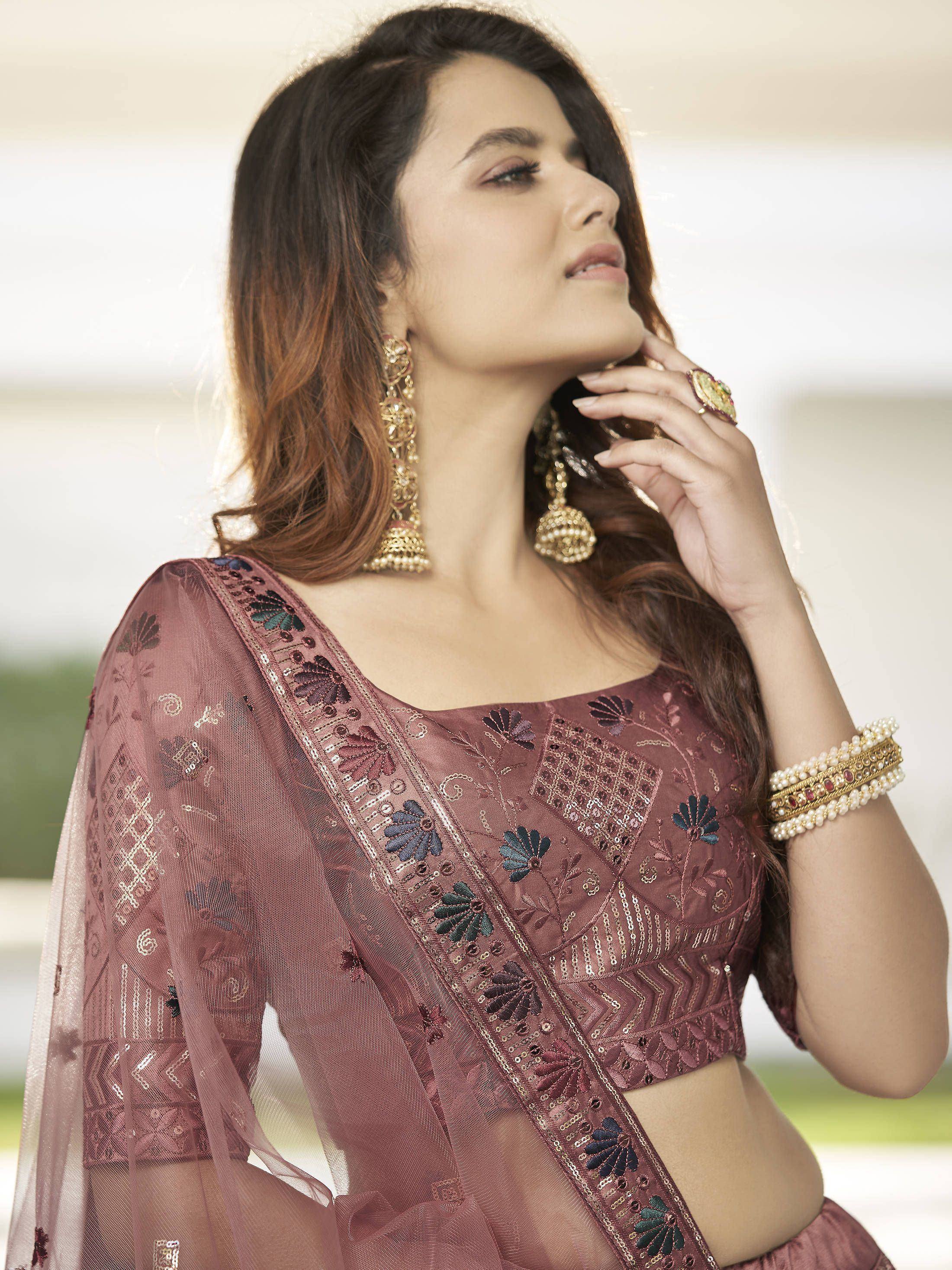 Elegant maroon embroidered lehenga choli with sheer dupatta and gold jewelry for Indian ethnic wear