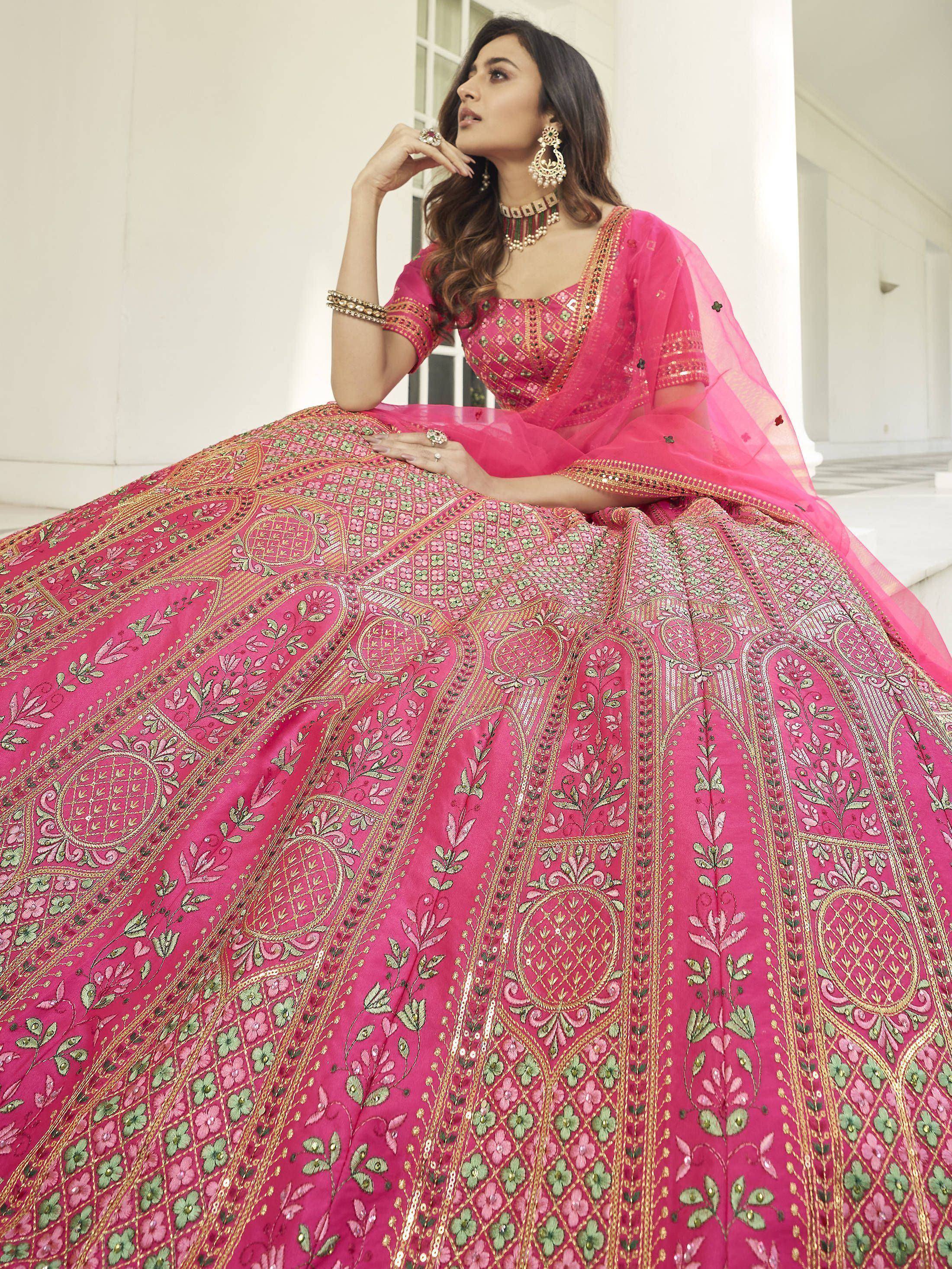 Pink embroidered lehenga choli with gold and green floral motifs, perfect for Indian ethnic wear