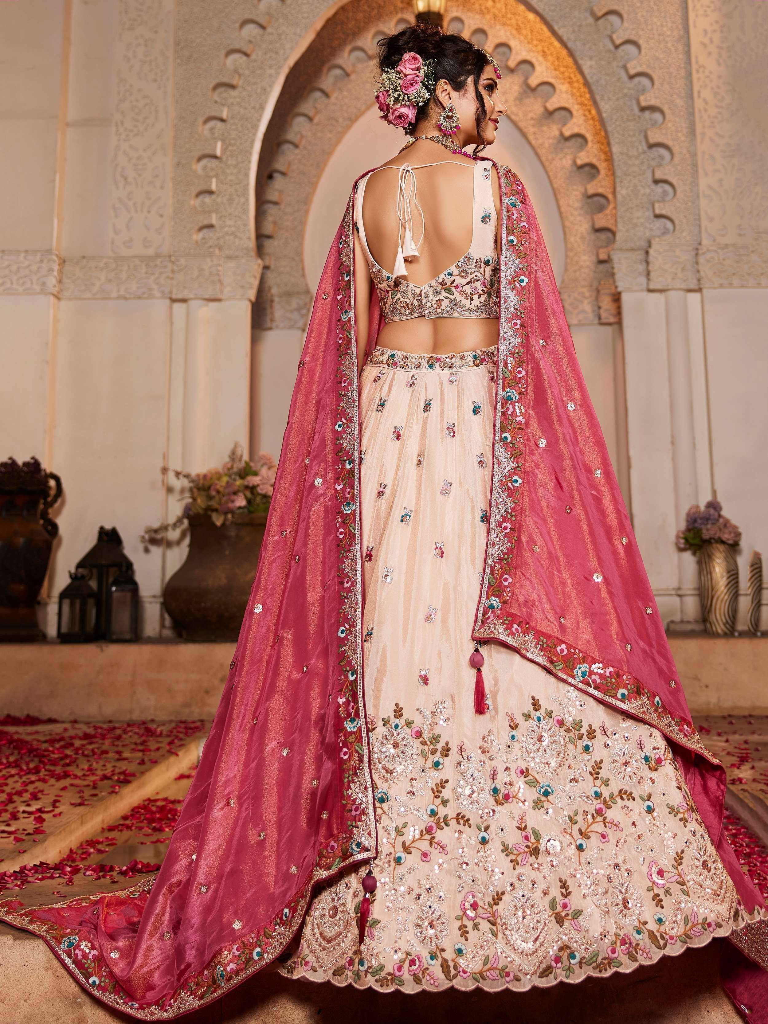 Elegant cream lehenga choli with pink dupatta, floral embroidery, and back tie blouse for Indian weddings