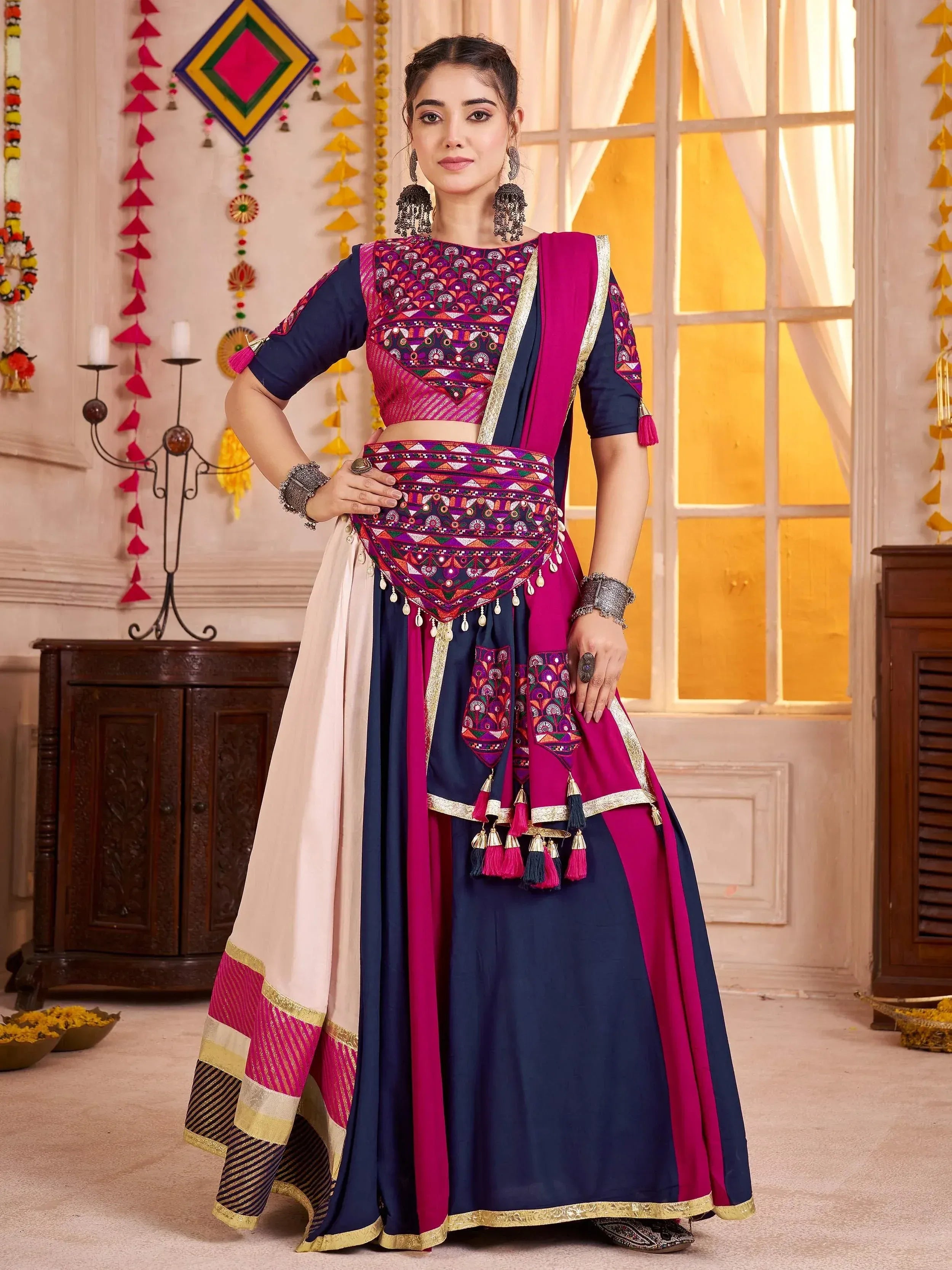 Elegant Indian ethnic wear with embroidered lehenga choli in navy and magenta, perfect for festive occasions.
