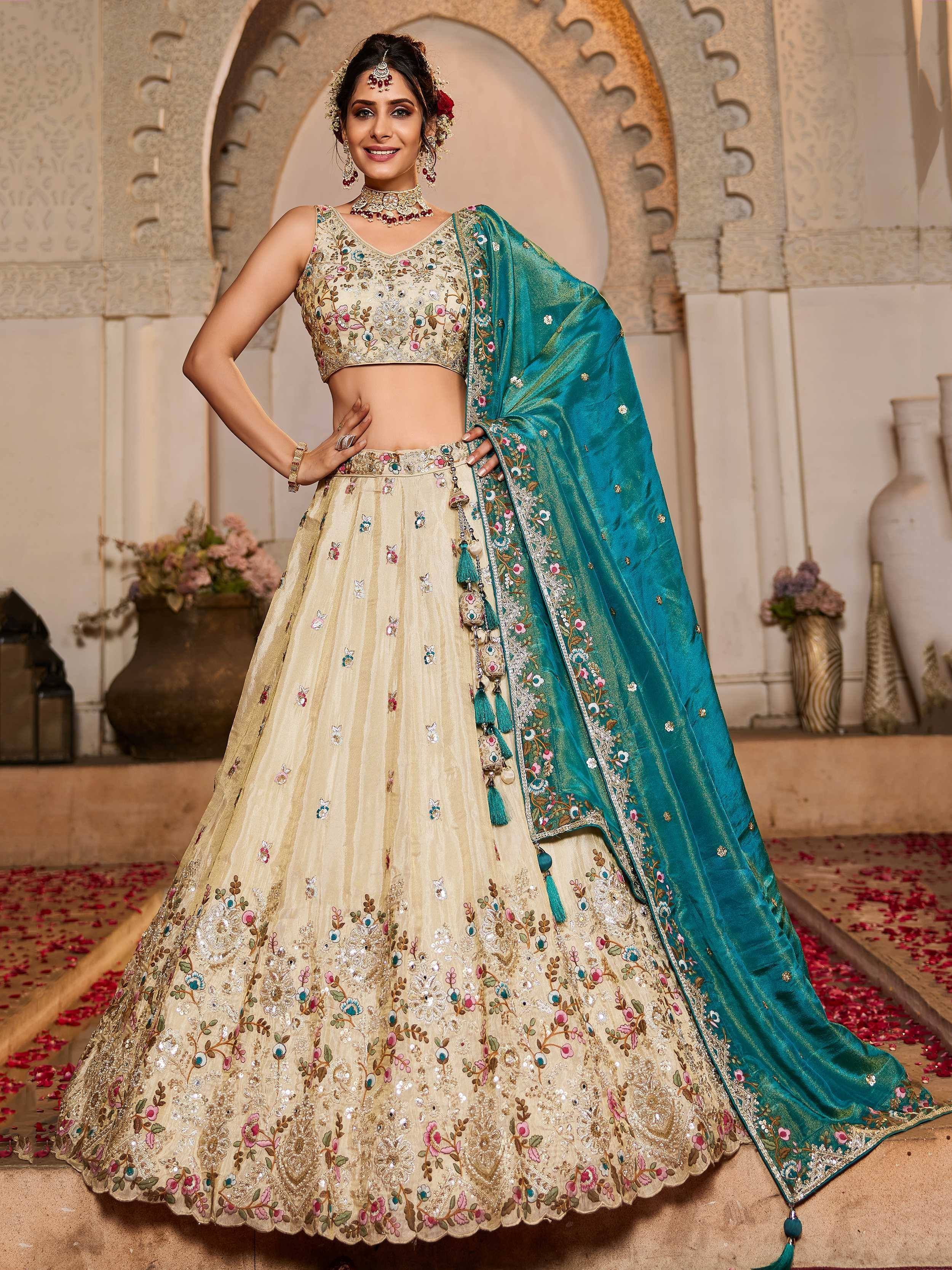 Elegant beige floral embroidered lehenga choli with teal dupatta, perfect for Indian weddings and celebrations