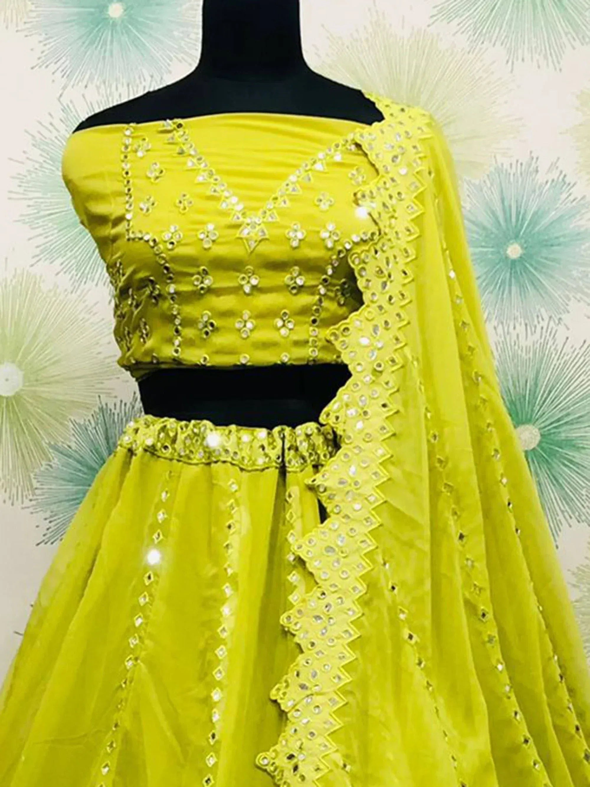 Vibrant yellow lehenga choli with mirror work and off-shoulder blouse, perfect for Indian ethnic occasions