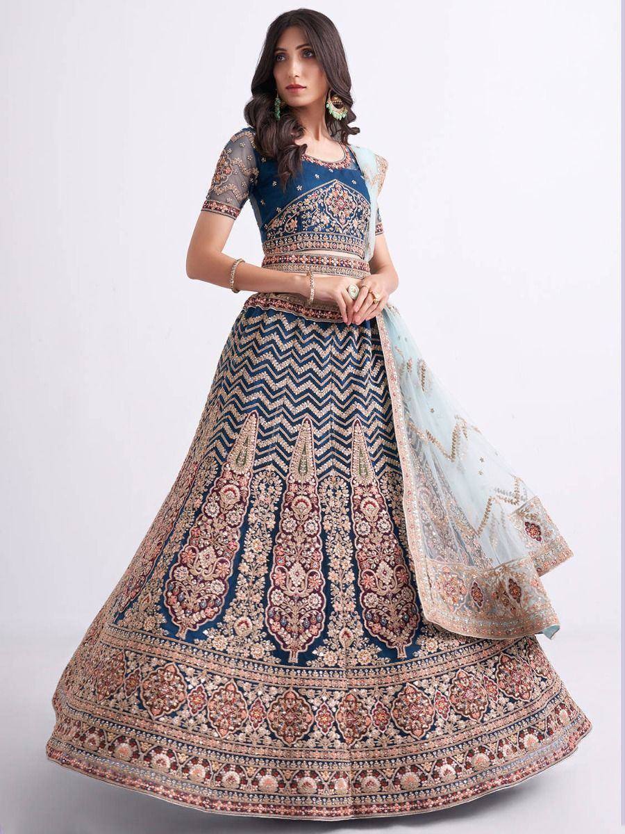 Blue embroidered lehenga choli with intricate gold and pink patterns, paired with sheer dupatta for Indian ethnic wear