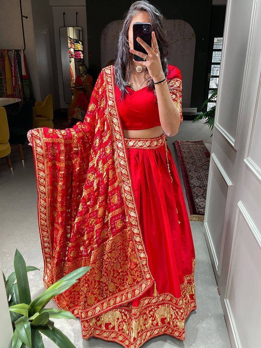Red and gold embroidered lehenga choli with matching dupatta, perfect for Indian ethnic wear occasions.