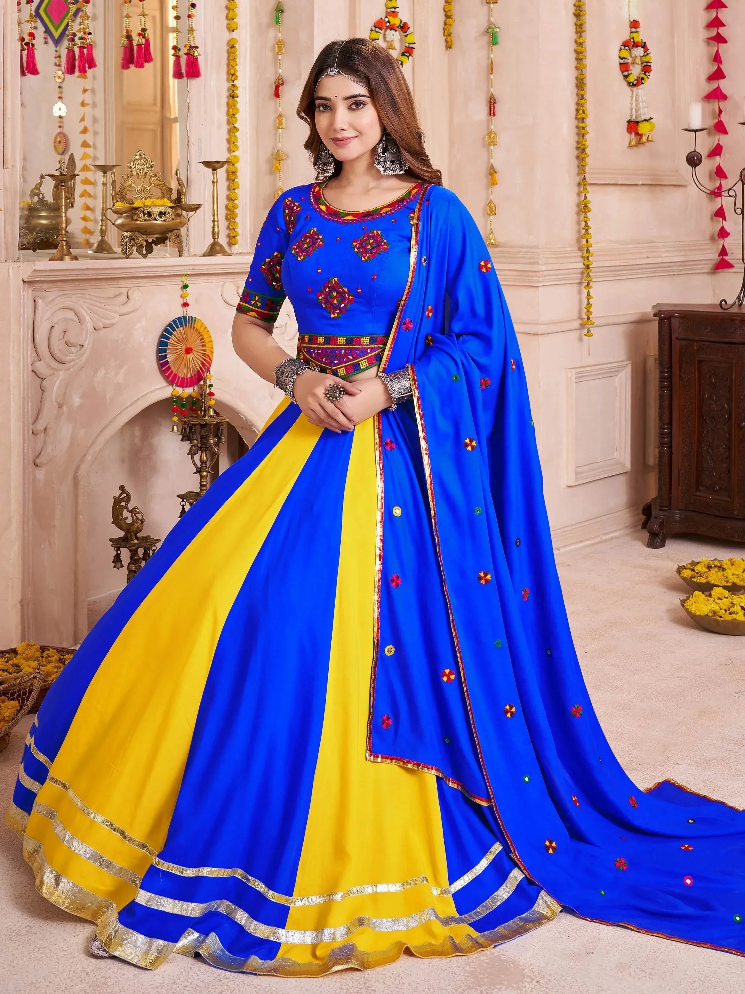Vibrant blue and yellow embroidered lehenga choli with mirror work, perfect for Indian ethnic occasions.