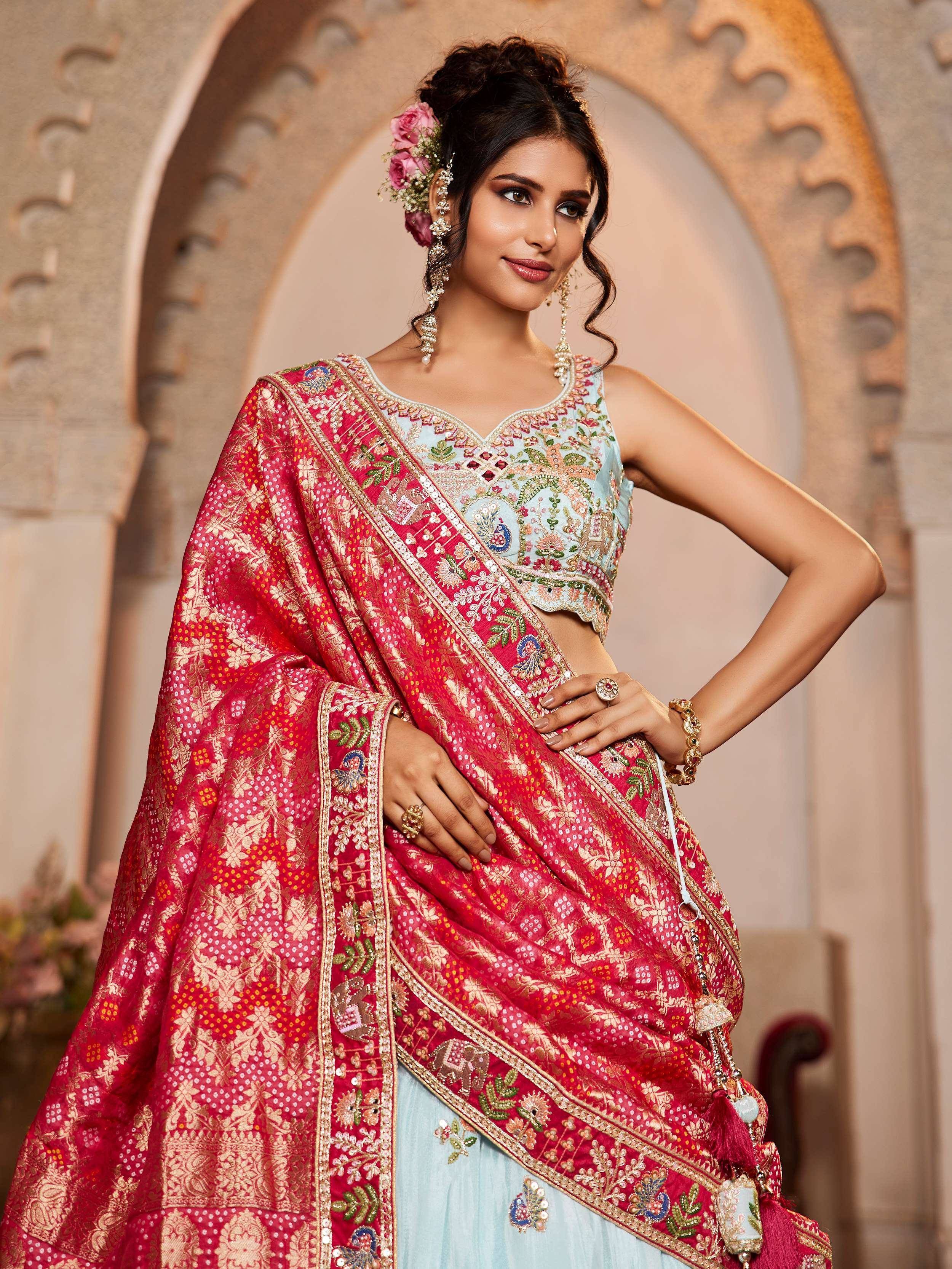 Elegant red and gold embroidered lehenga choli with floral details, perfect for Indian ethnic wear.