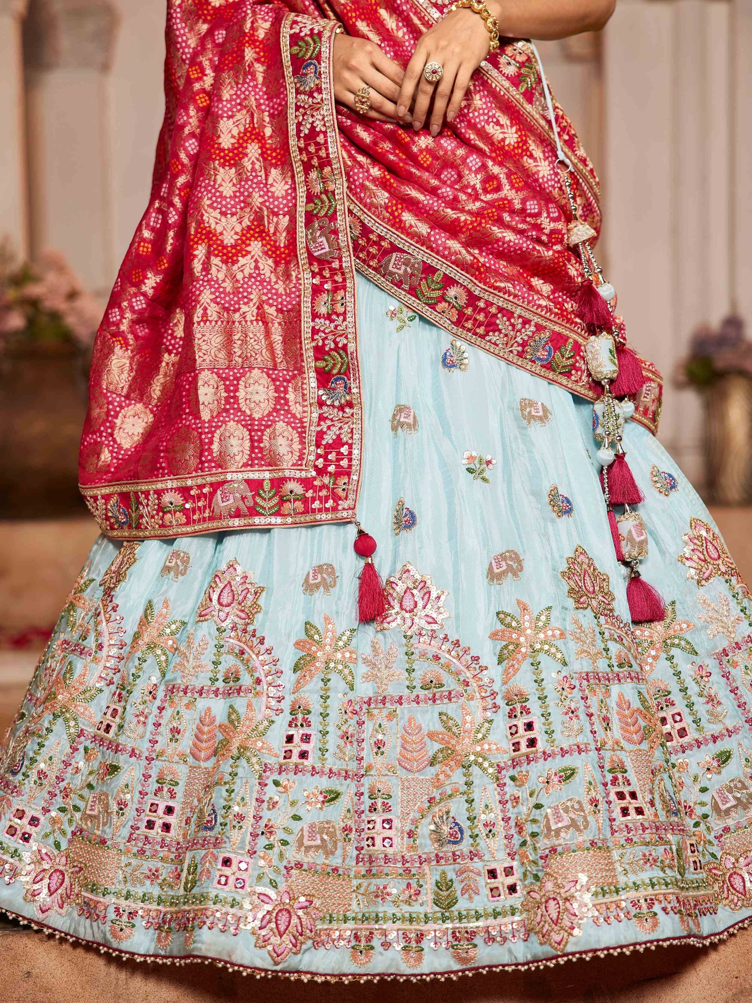 Blue and pink embroidered lehenga choli with floral and elephant motifs, perfect for Indian ethnic wear