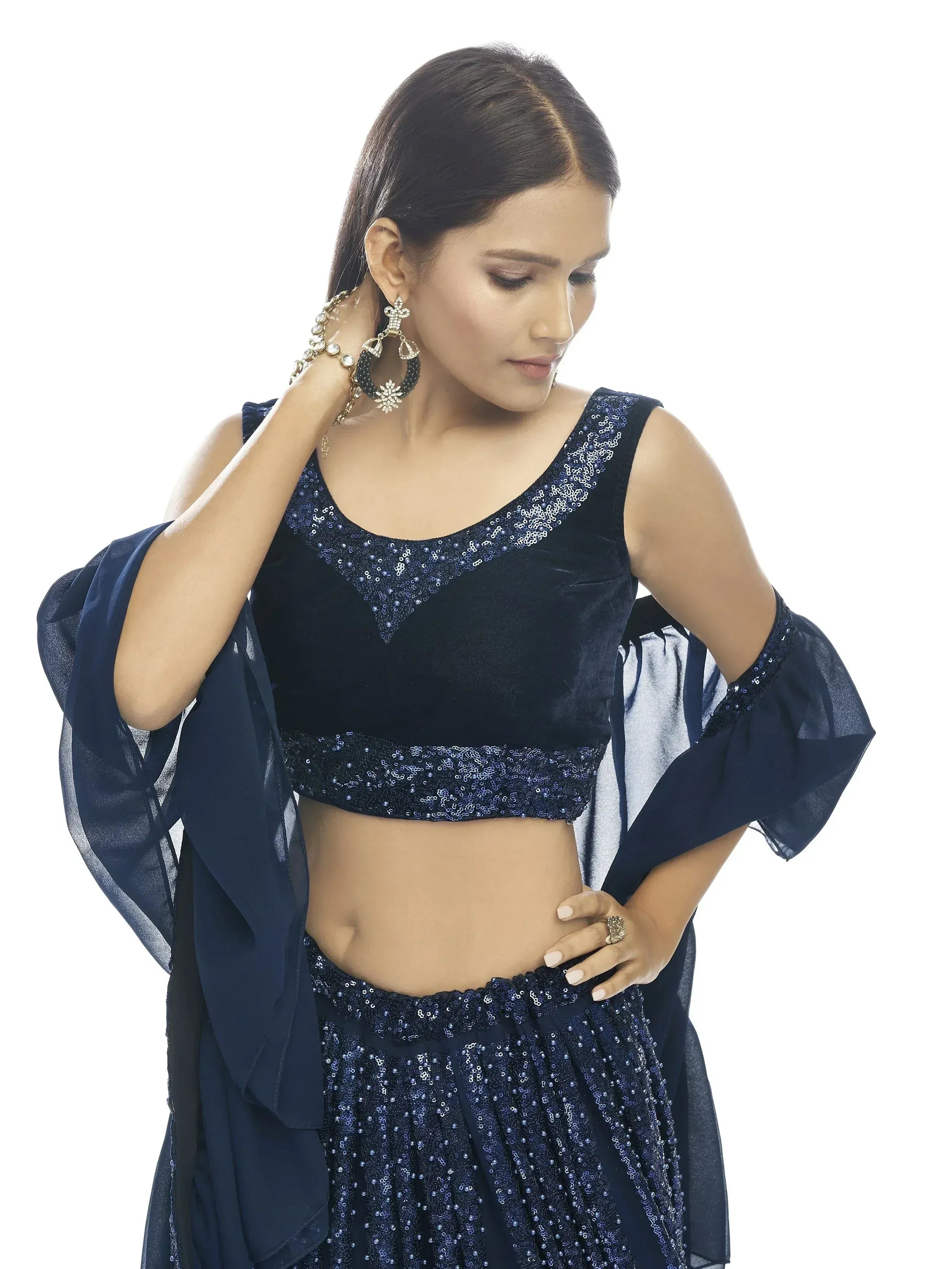 Navy blue sequined lehenga choli with velvet blouse and sheer cape, perfect for Indian ethnic wear events.