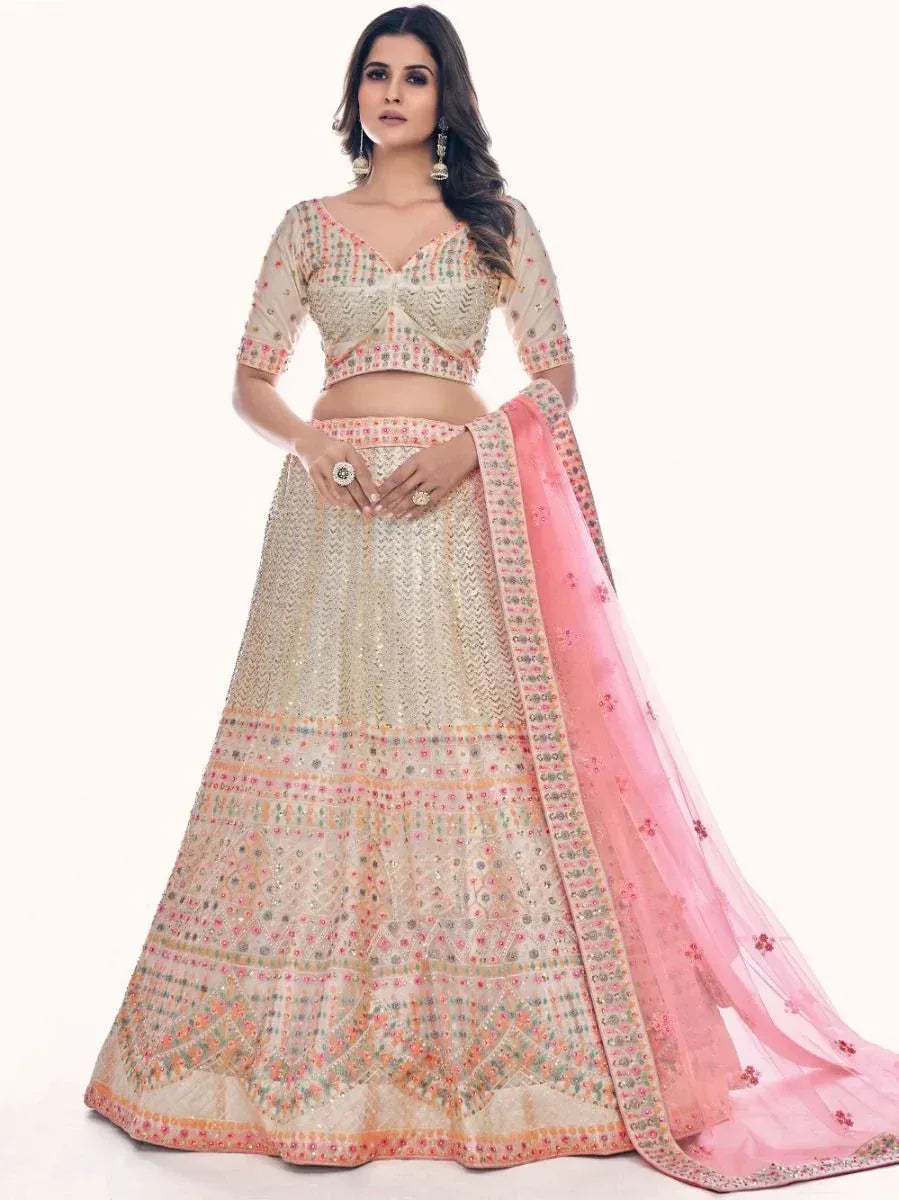 Designer lehenga choli with intricate embroidery and pink dupatta, perfect for Indian ethnic occasions