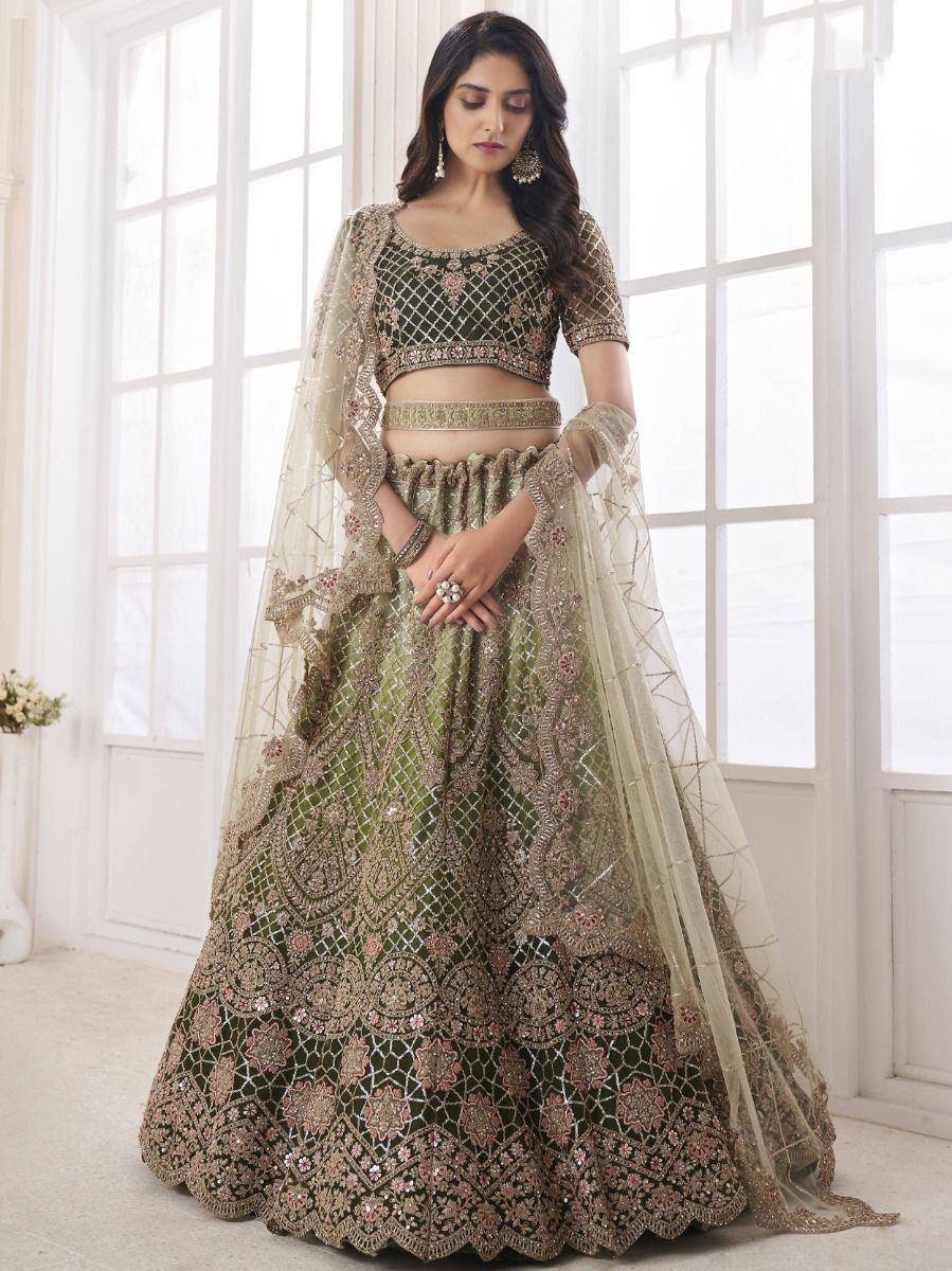 Elegant green and gold embroidered lehenga choli with sheer dupatta, perfect for Indian weddings and festive occasions.