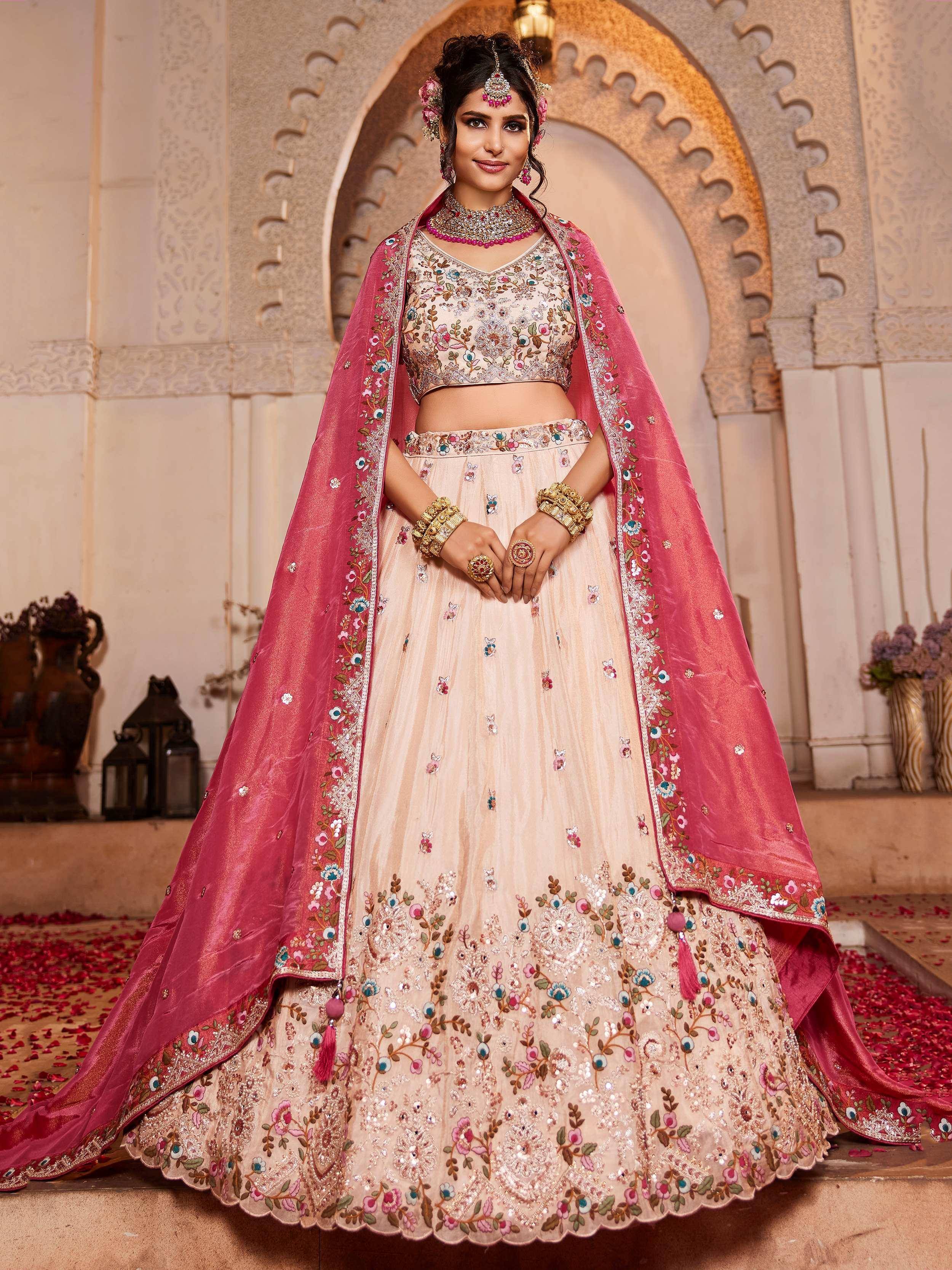 Elegant beige lehenga choli with floral embroidery, paired with a pink dupatta, perfect for Indian weddings and festive occasions.