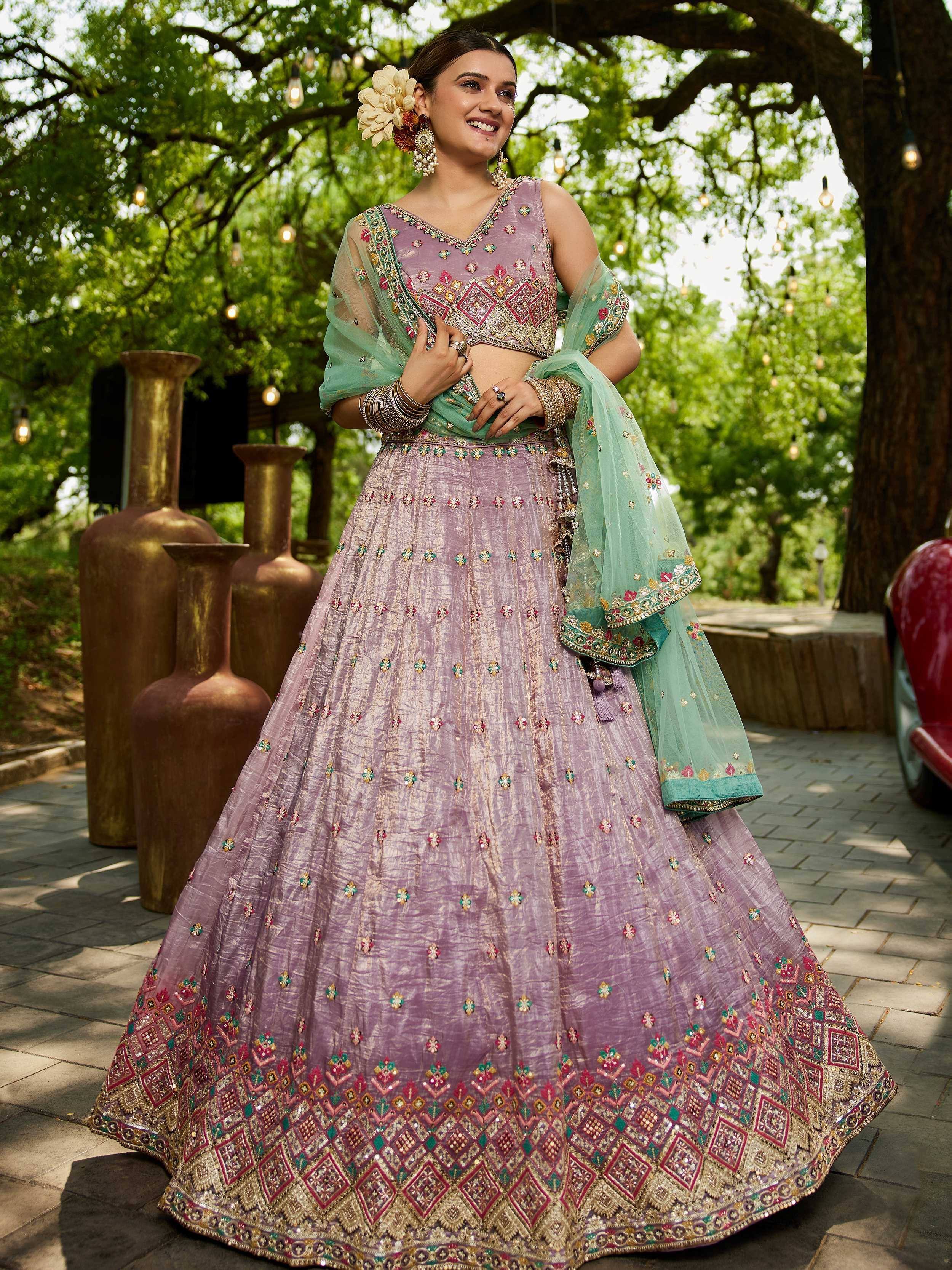Lavender embroidered lehenga choli with green dupatta, perfect for Indian weddings and festive occasions.