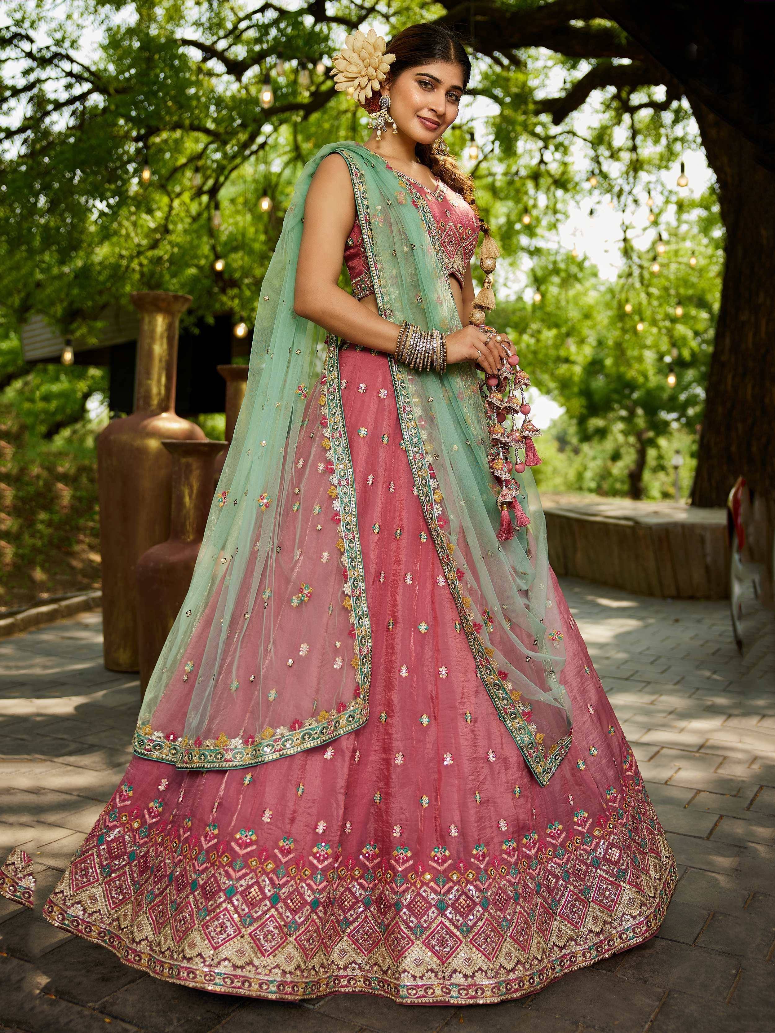 Pink embroidered lehenga choli with mint green dupatta, perfect for Indian weddings and festive occasions.