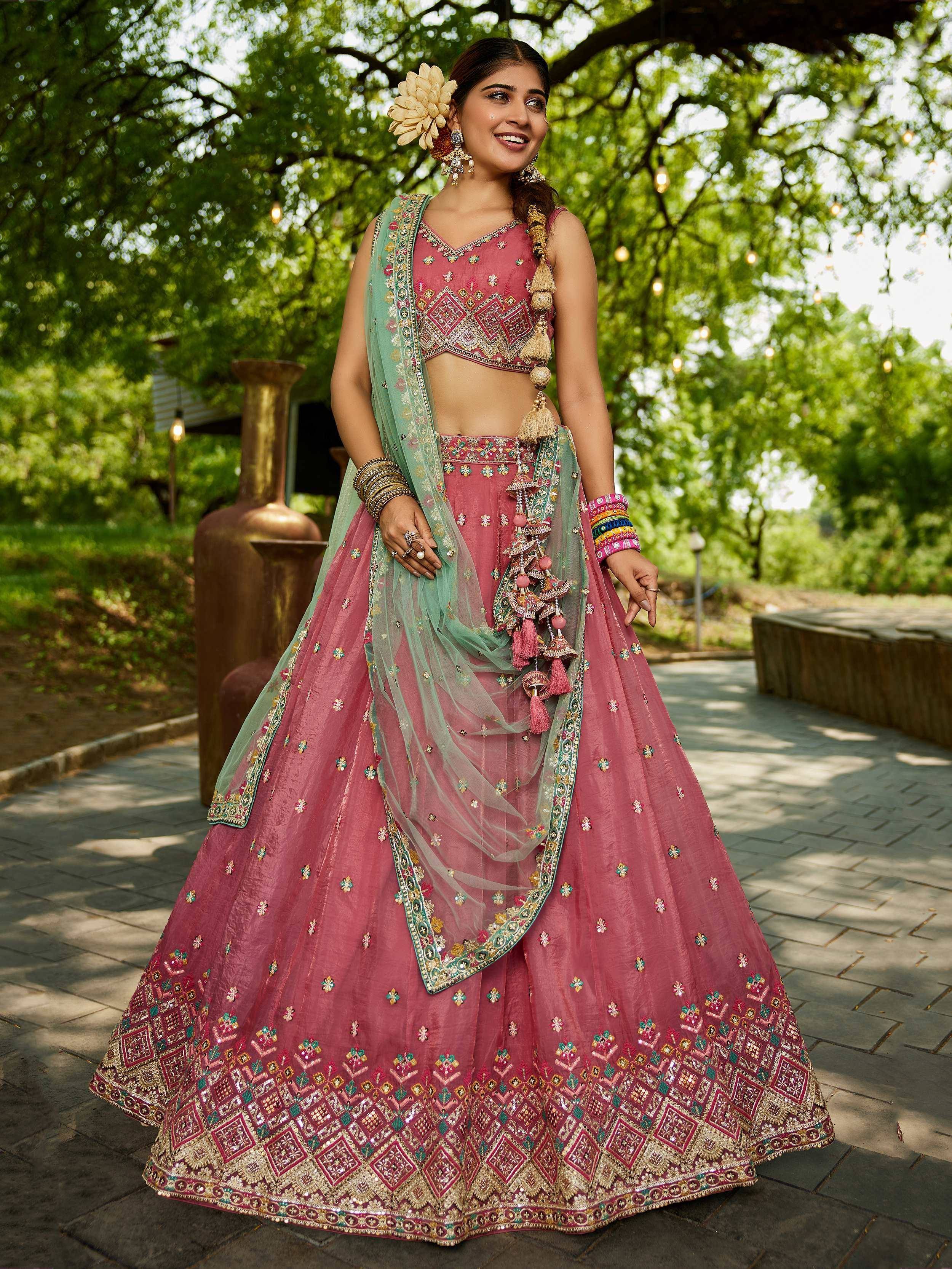 Pink embroidered lehenga choli with green dupatta, perfect for Indian weddings and festive occasions
