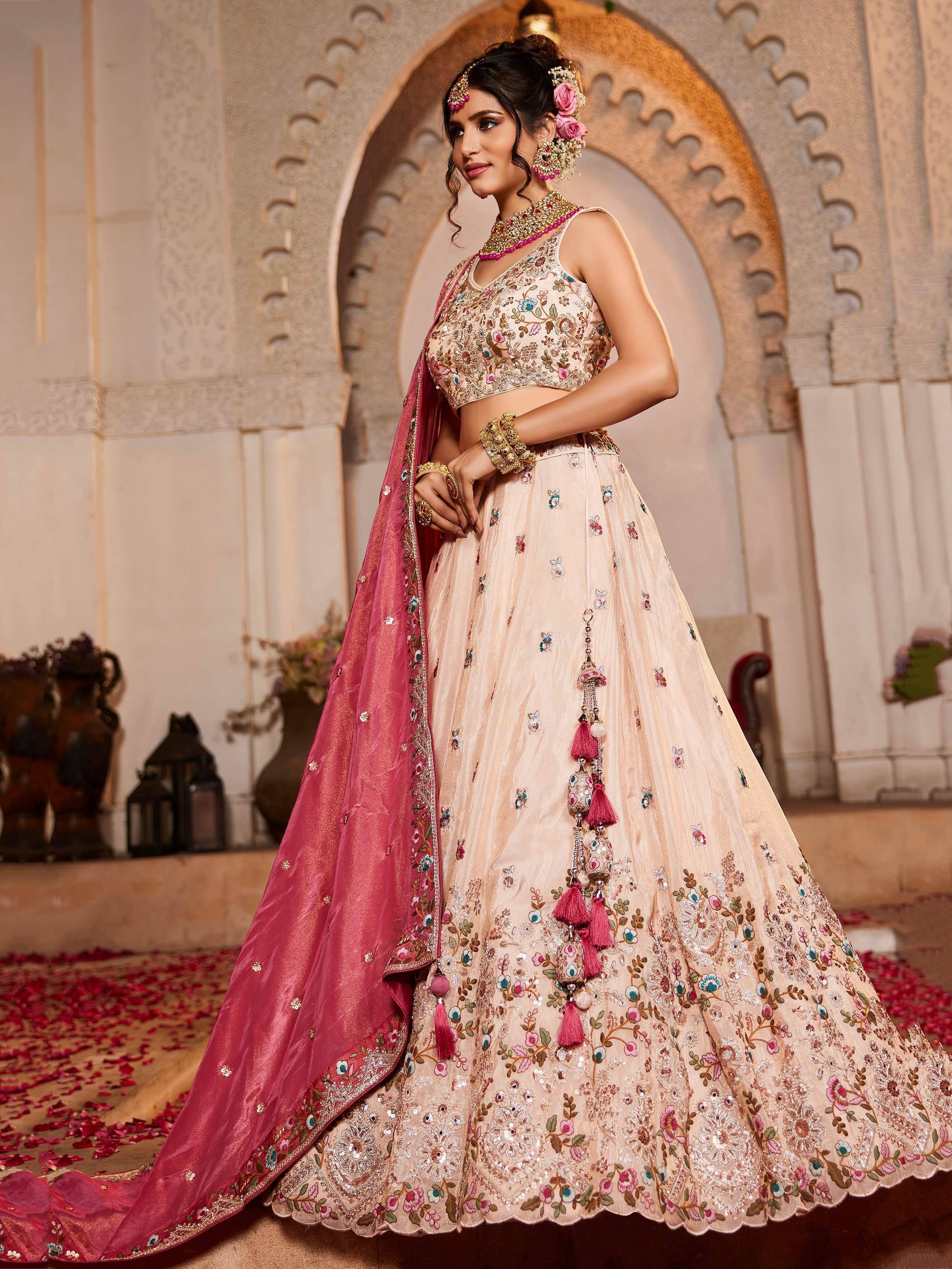 Elegant beige floral lehenga choli with pink dupatta, perfect for Indian weddings and ethnic events.