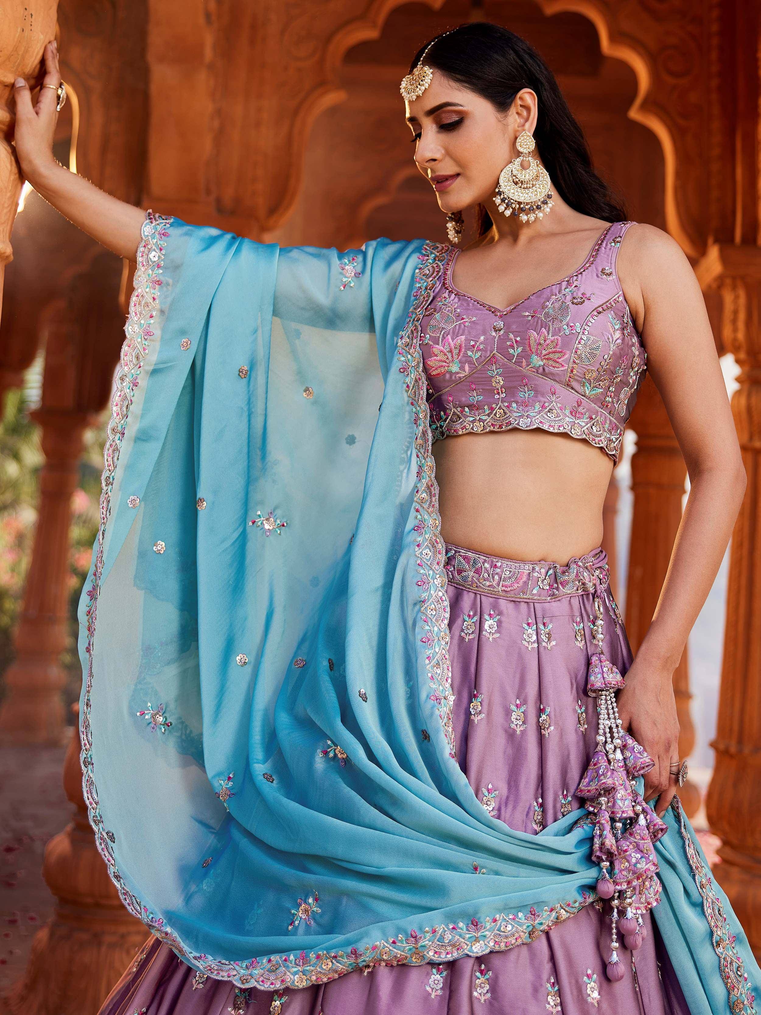 Elegant purple lehenga choli with floral embroidery, paired with a light blue dupatta, perfect for Indian ethnic wear.