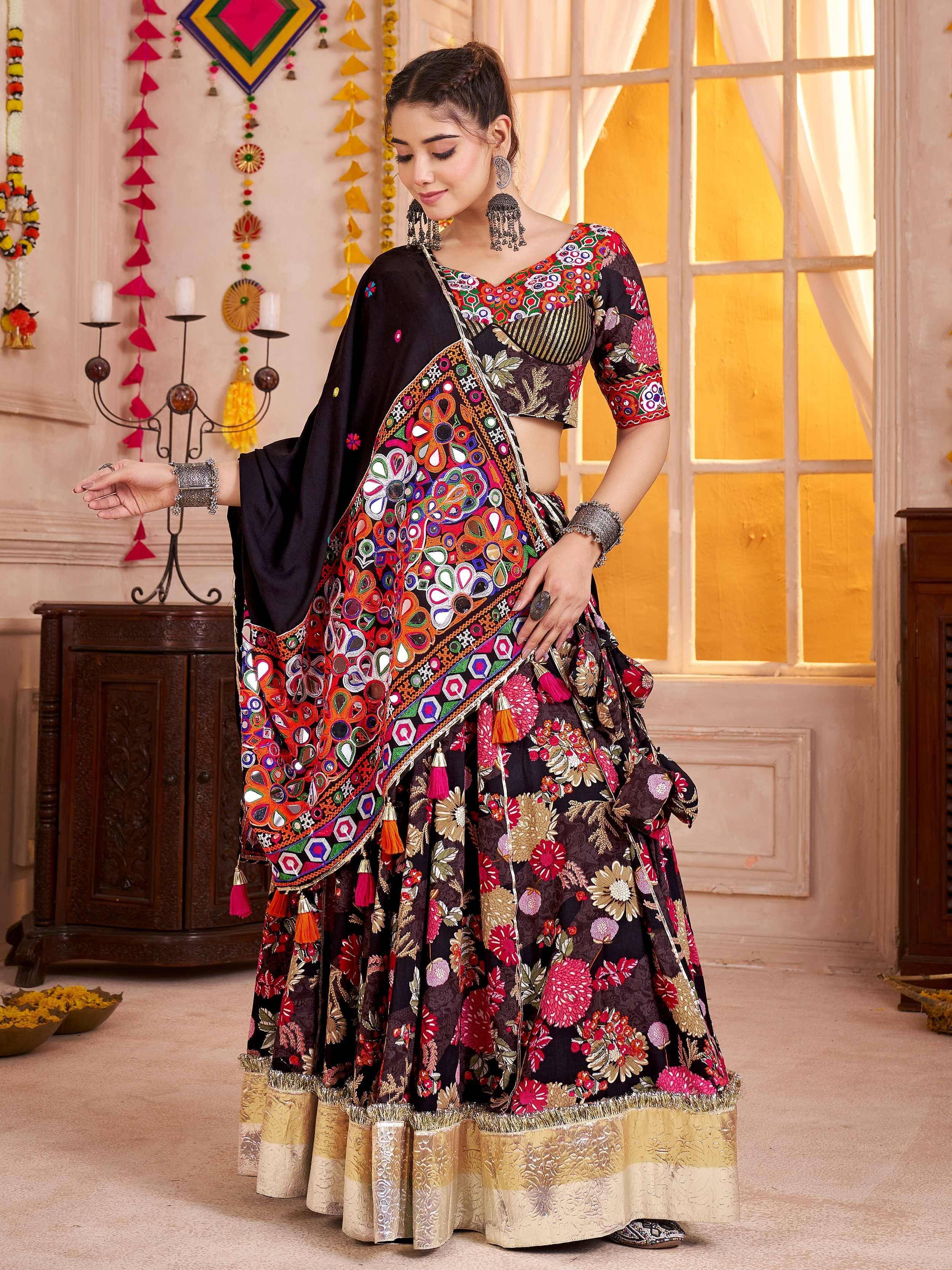 Black floral lehenga choli with mirror work and tassels, perfect for Indian ethnic wear occasions.