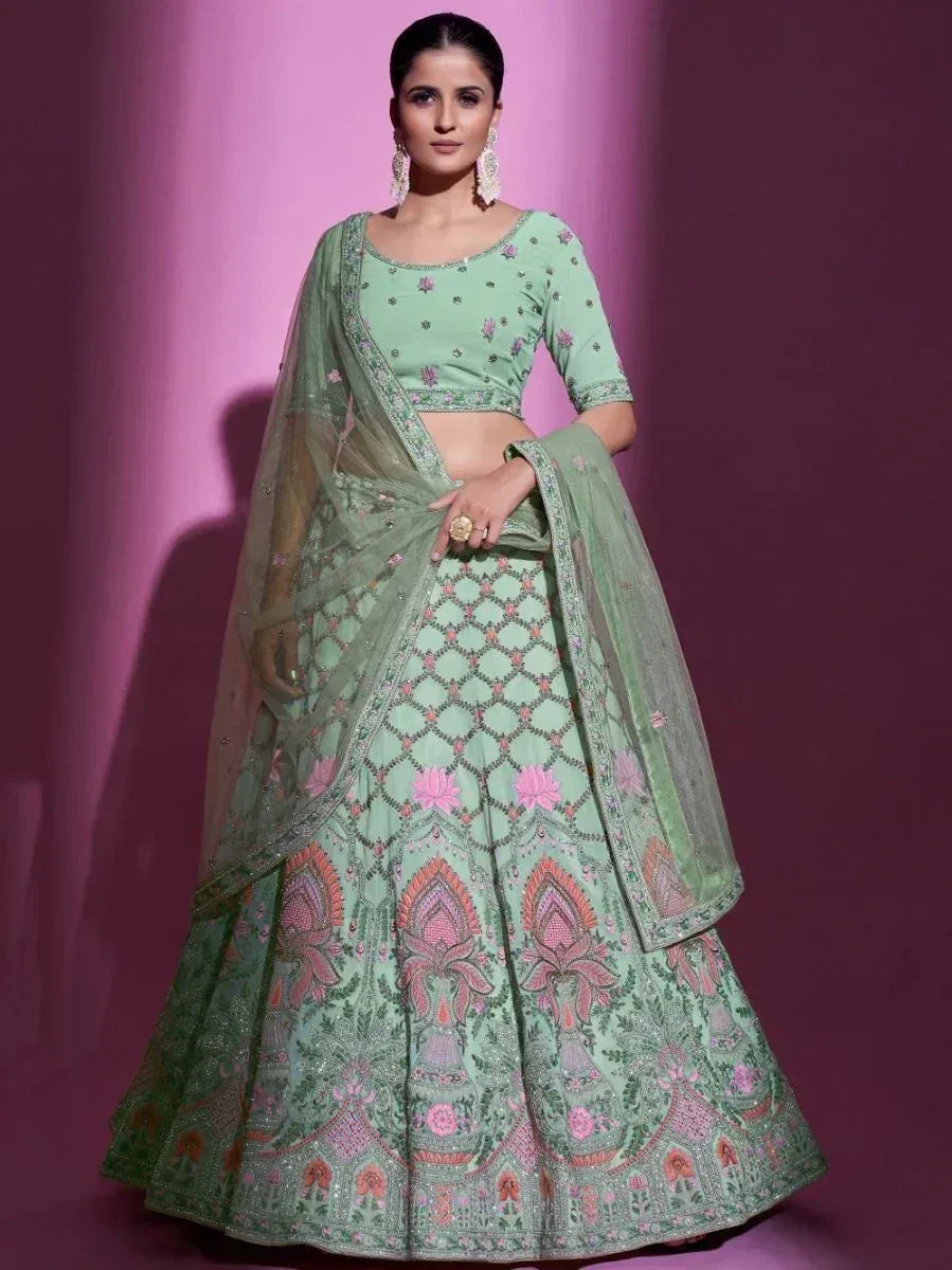 Mint green designer lehenga choli with pink floral embroidery and sheer dupatta for Indian ethnic wear