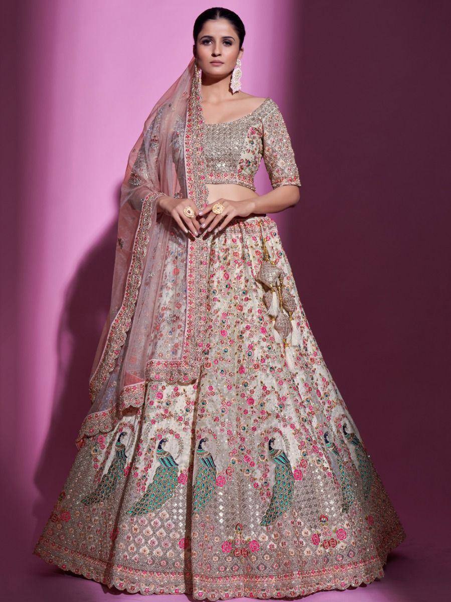 Elegant Indian lehenga choli with peacock embroidery, floral motifs, and sheer dupatta for weddings or festivals