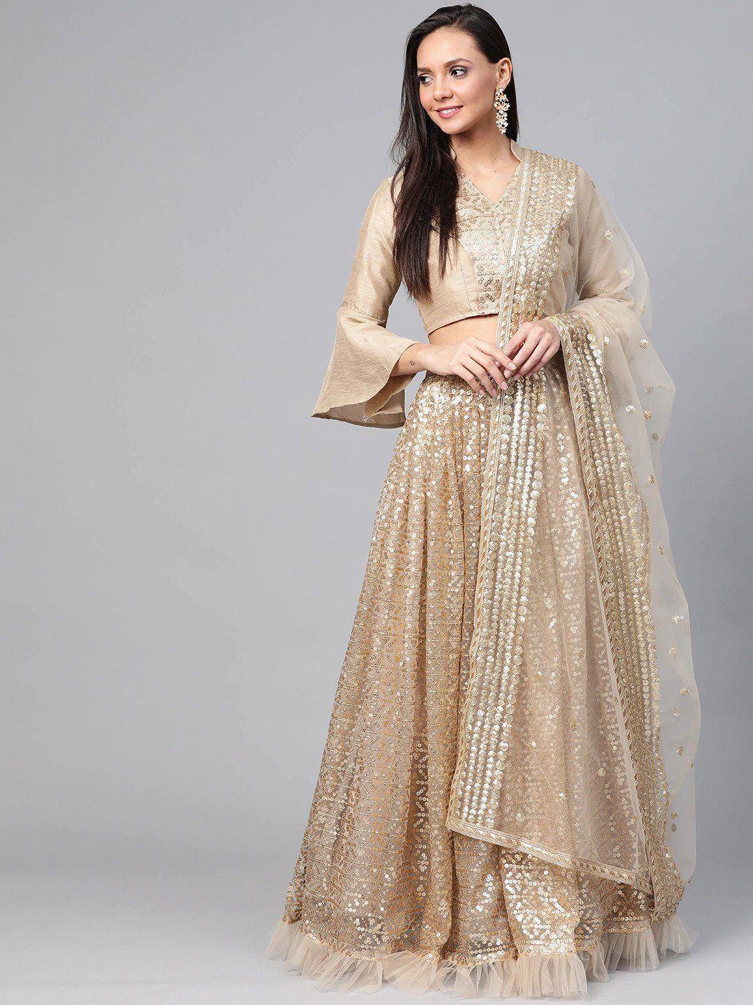 Gold sequin lehenga choli with bell sleeves and sheer dupatta, ethnic Indian wedding wear