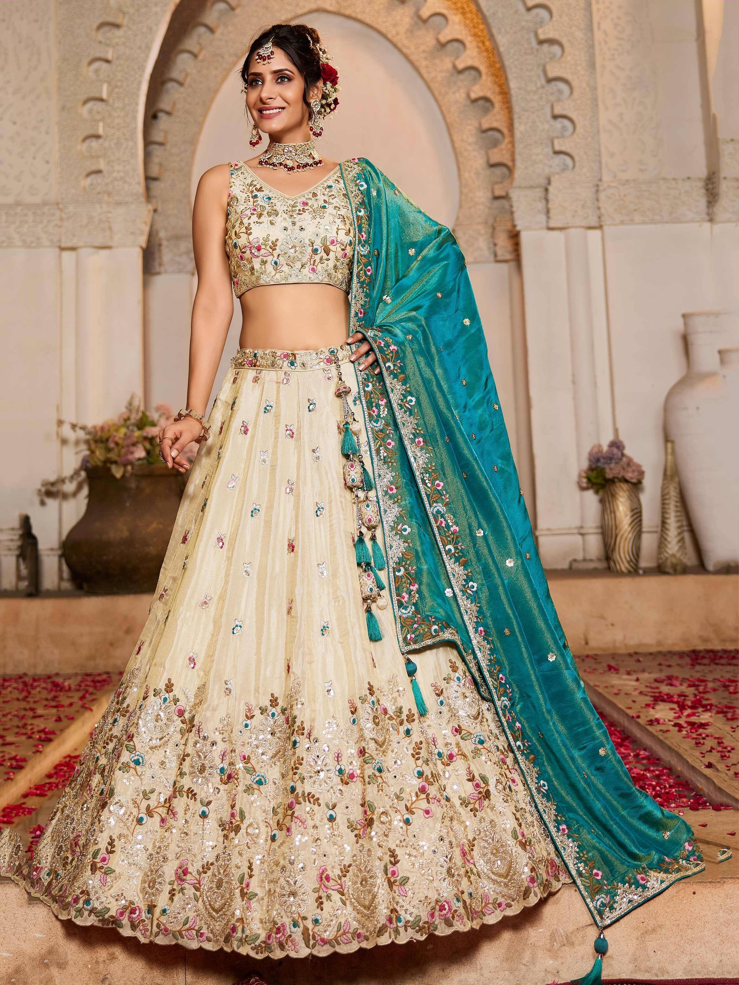 Elegant cream lehenga choli with floral embroidery and teal dupatta for Indian ethnic wear