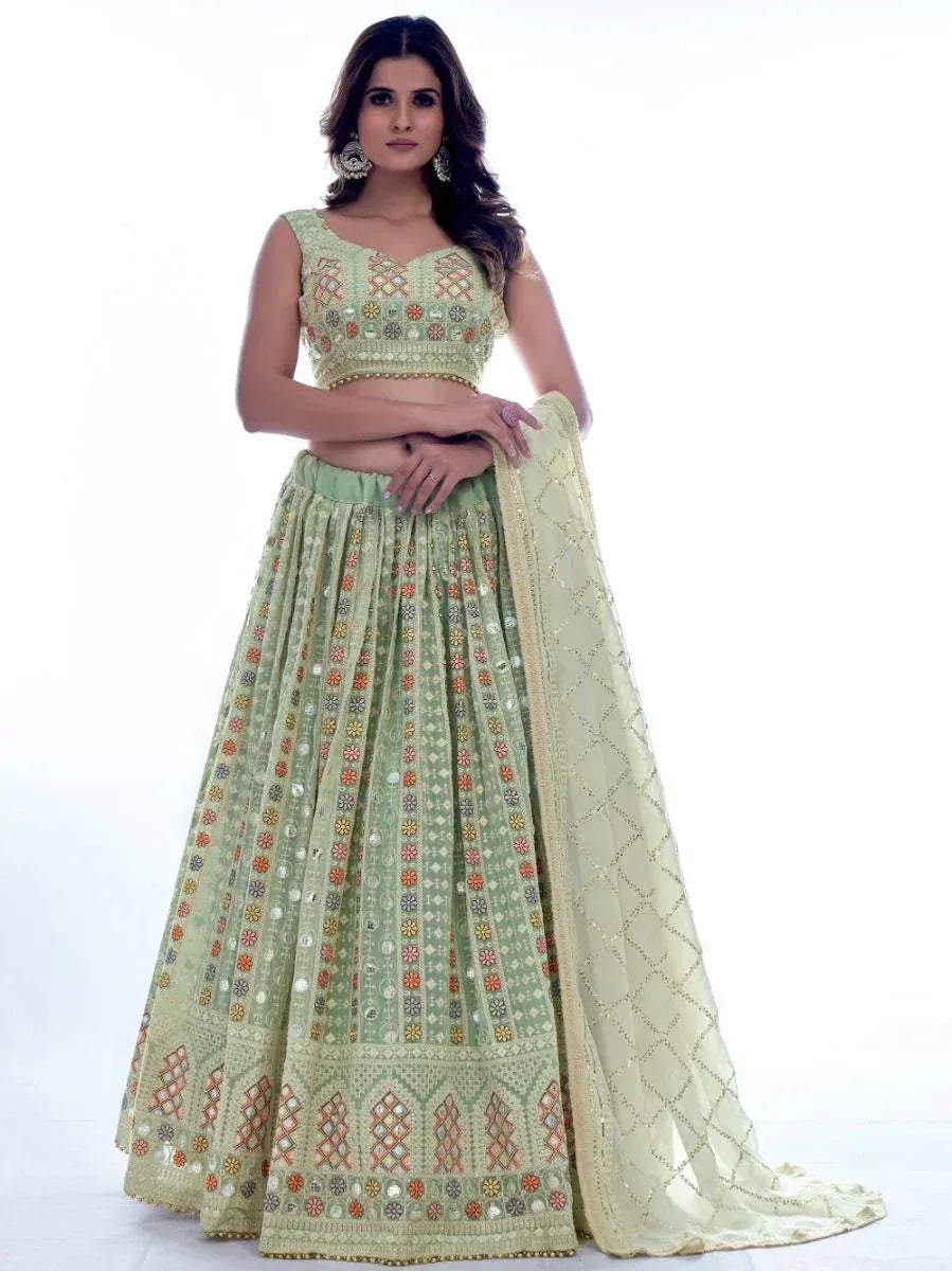 Light green embroidered lehenga choli with mirror work and dupatta, perfect for Indian ethnic occasions