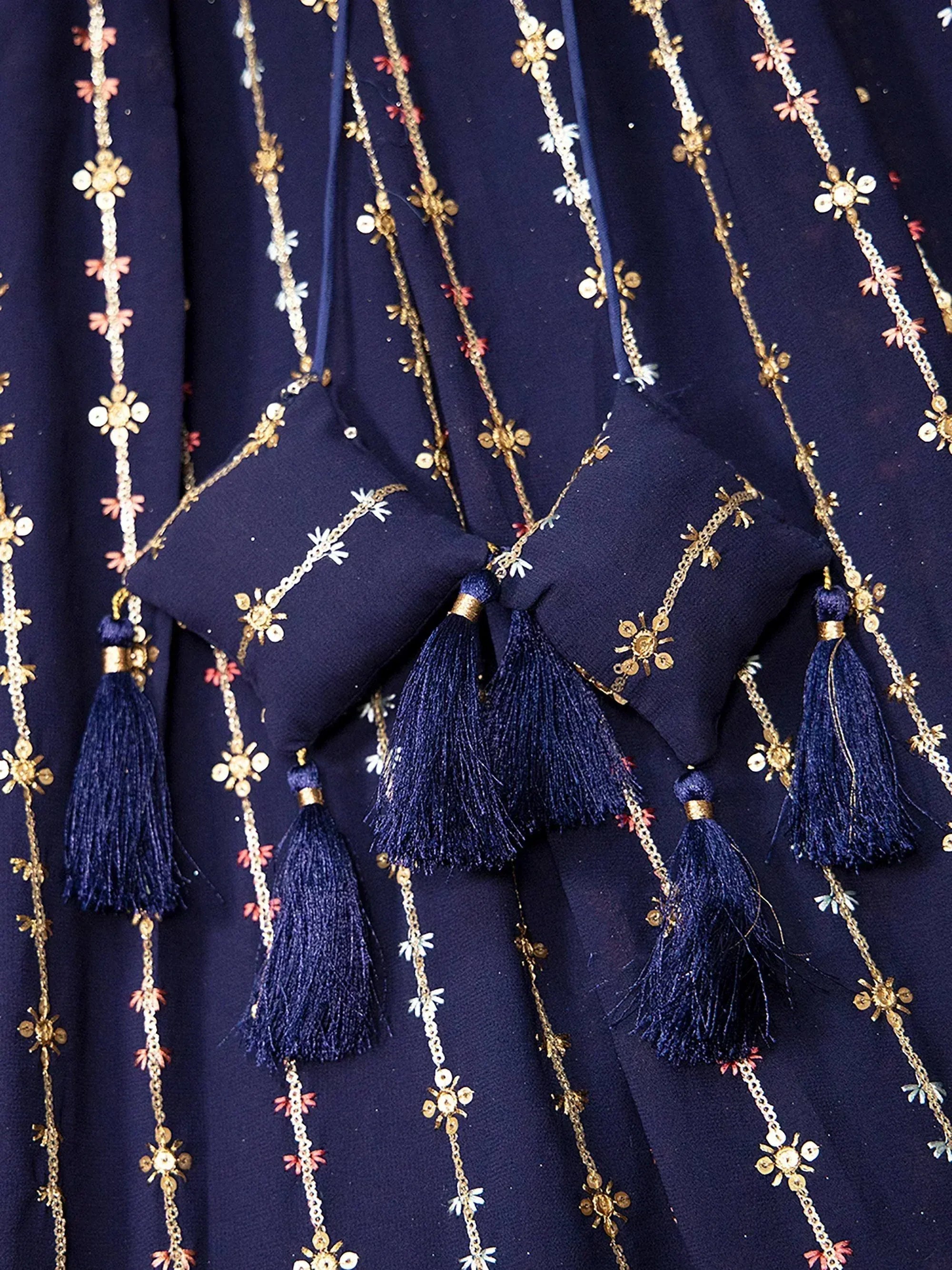 Navy blue ethnic gown with gold floral embroidery and tassels, perfect for Indian occasions
