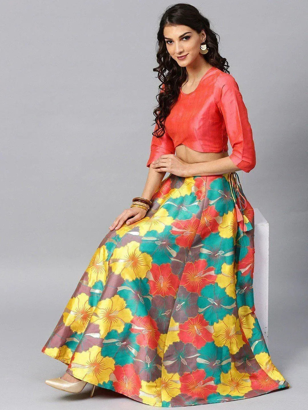 Vibrant floral lehenga choli with coral blouse, perfect for Indian ethnic wear