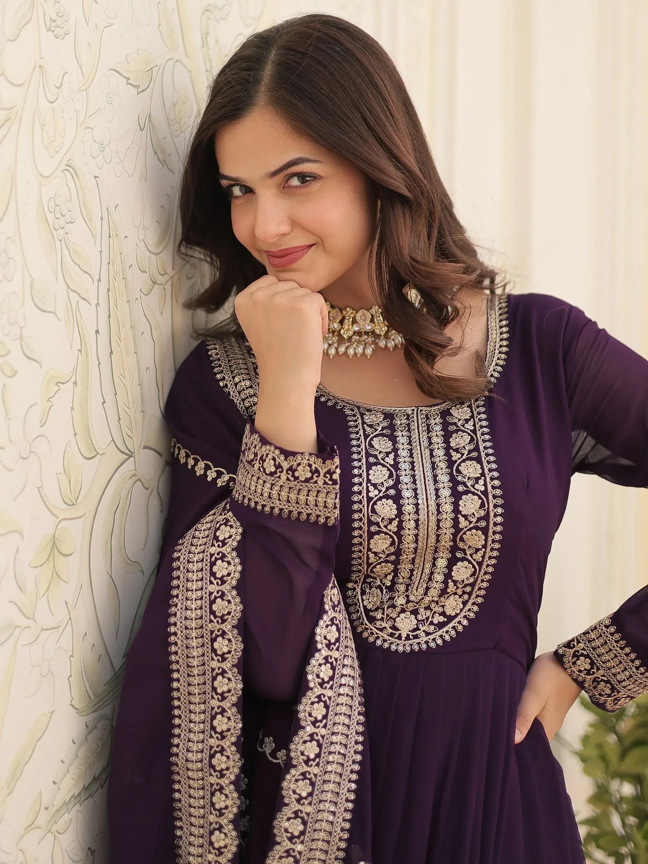 Purple embroidered ethnic gown with gold detailing, perfect for Indian festive occasions and weddings.