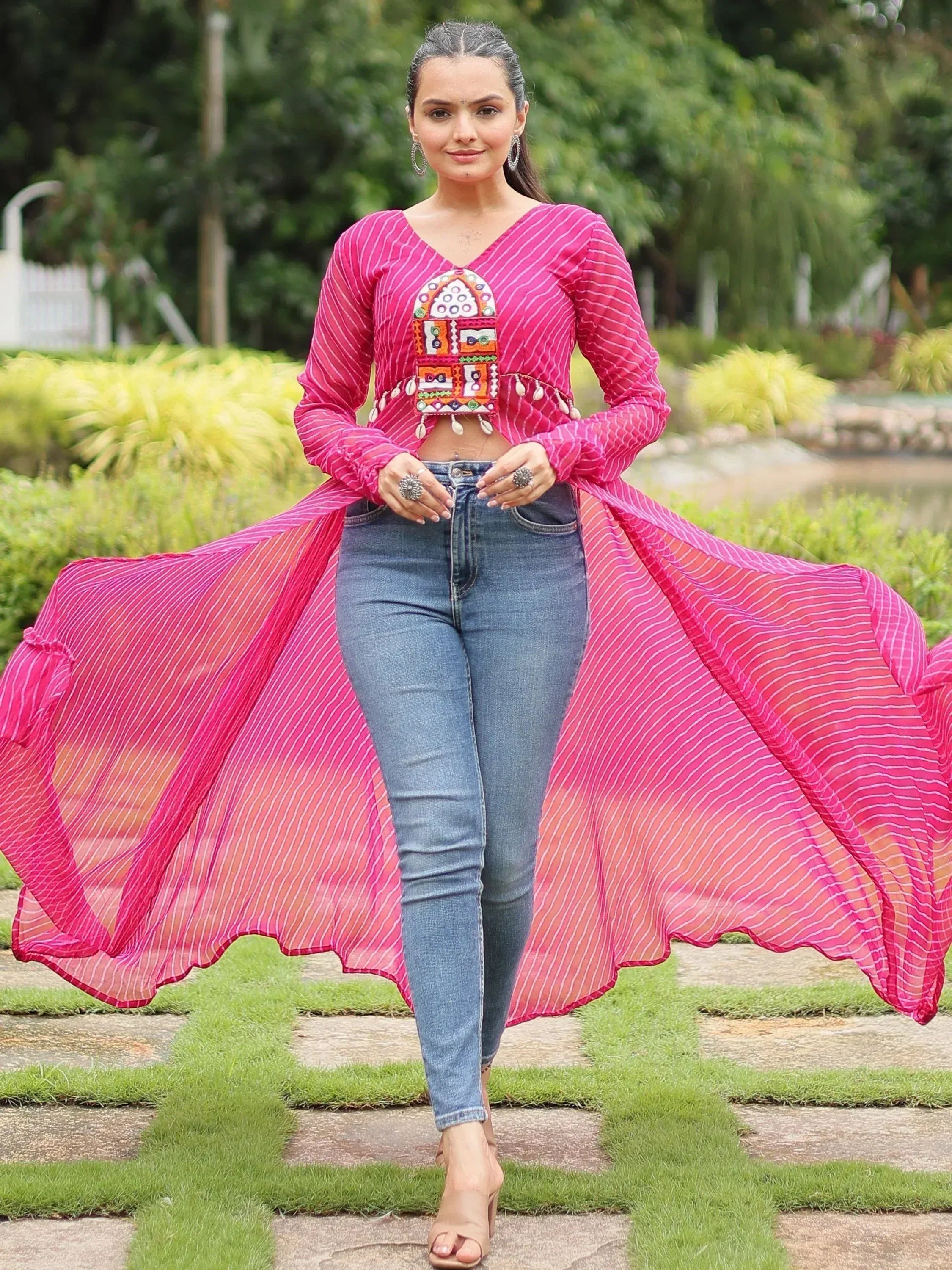 Pink striped ethnic crop top with mirror work, paired with jeans, perfect for fusion wear