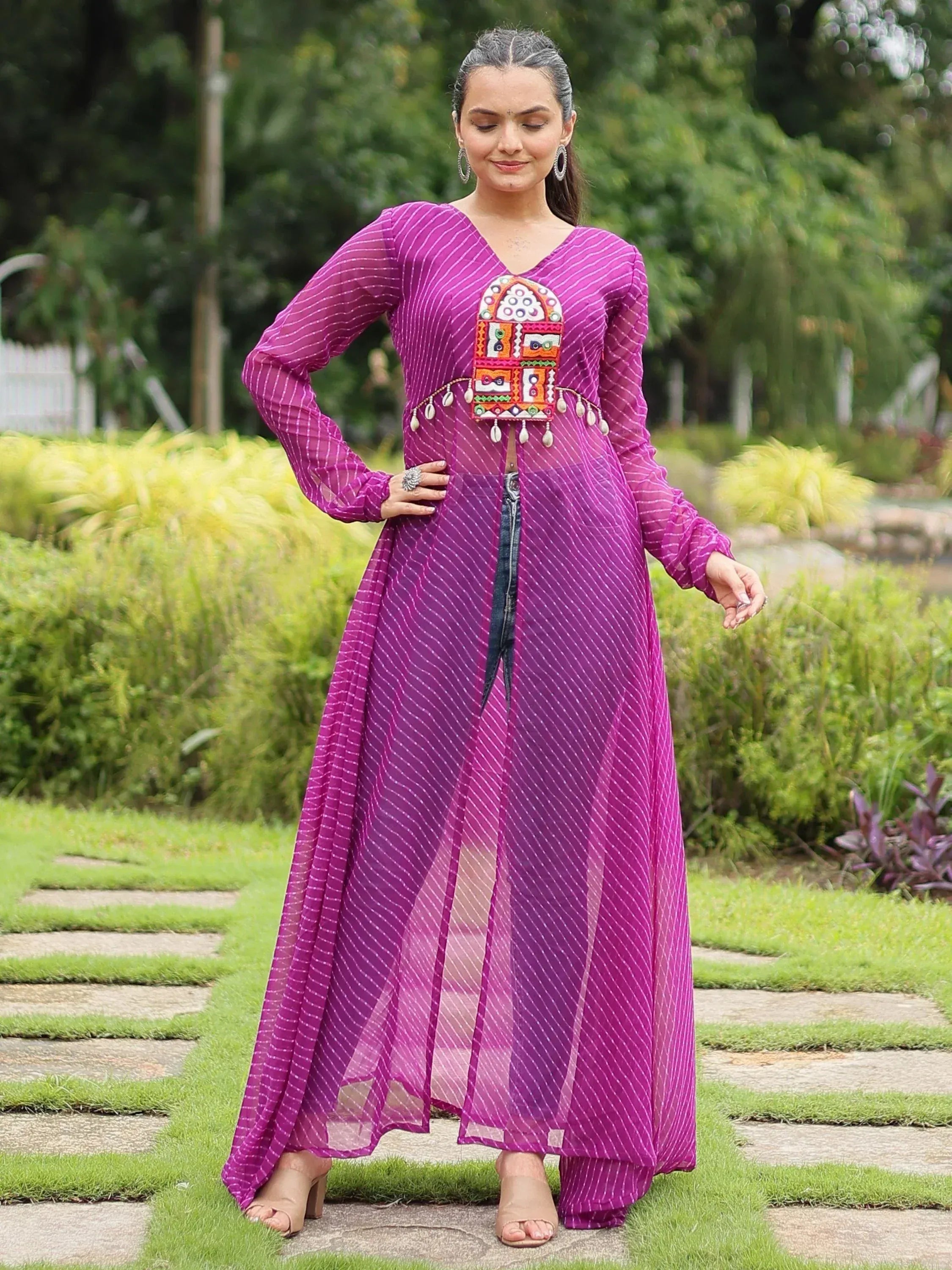 Purple ethnic gown with mirror work and striped design, perfect for Indian festive wear