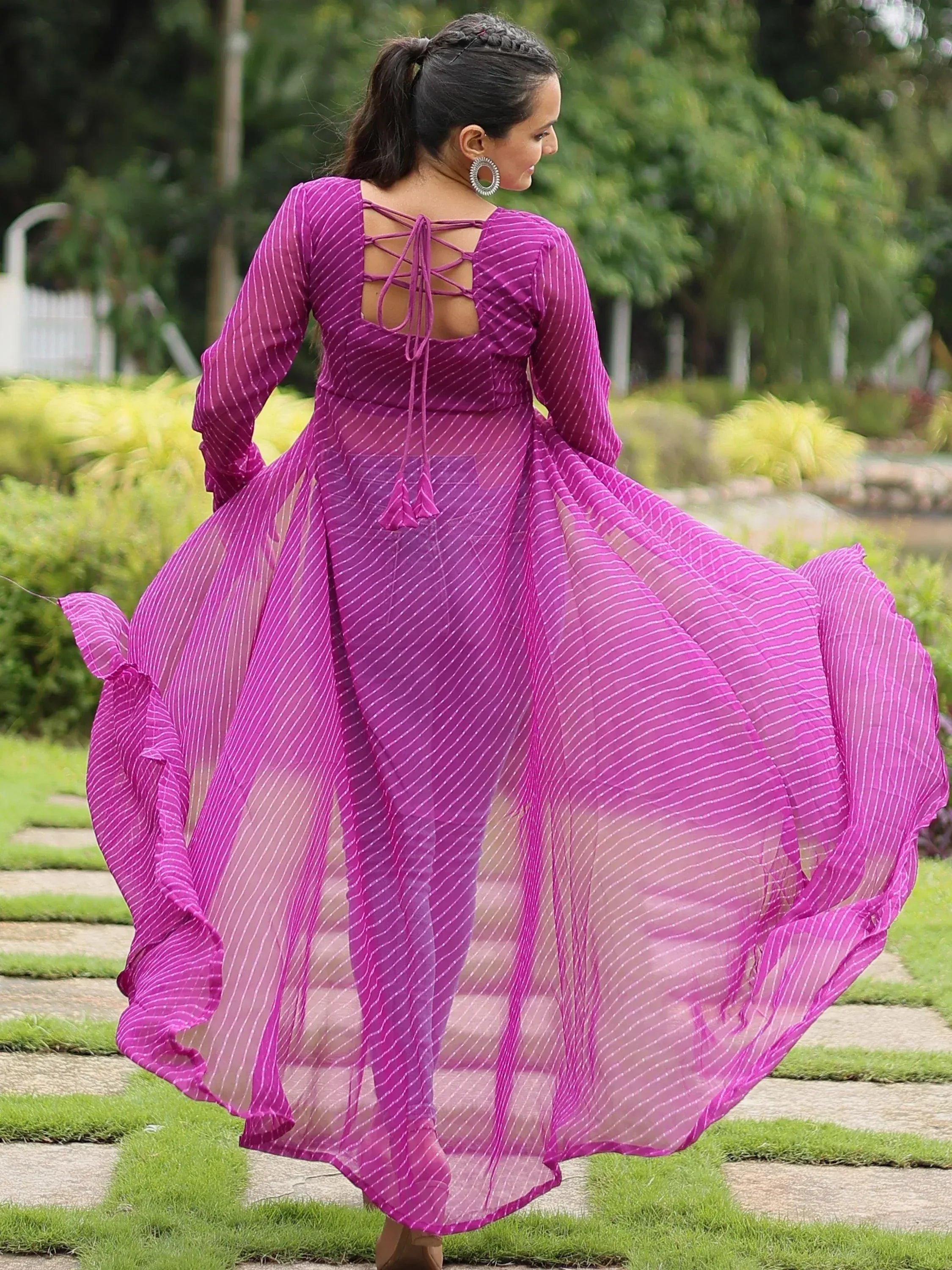 Purple striped ethnic gown with back tie detail, flowing in garden setting