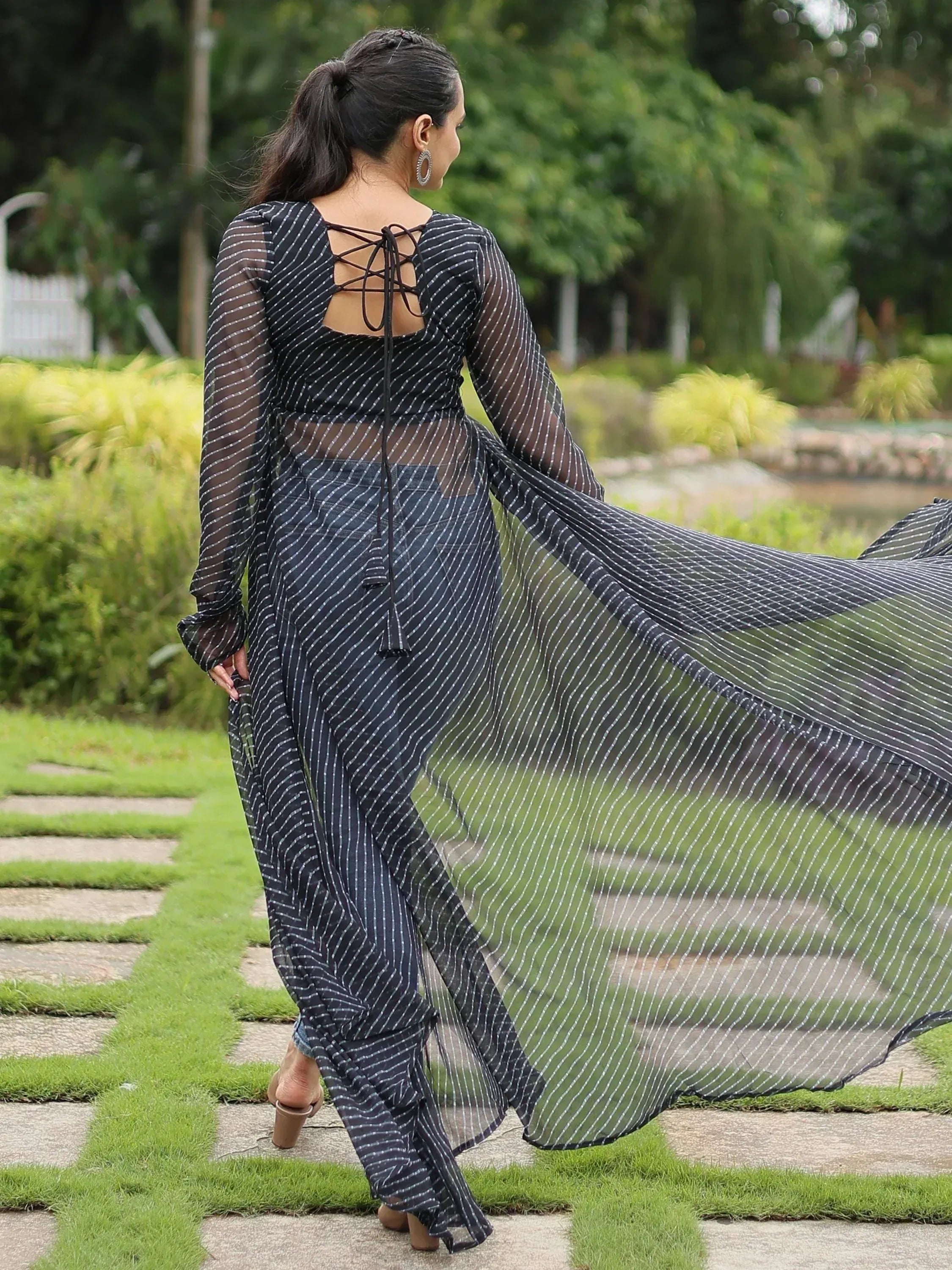 Black and white striped ethnic gown with sheer long sleeves and back tie detail, perfect for Indian occasions.