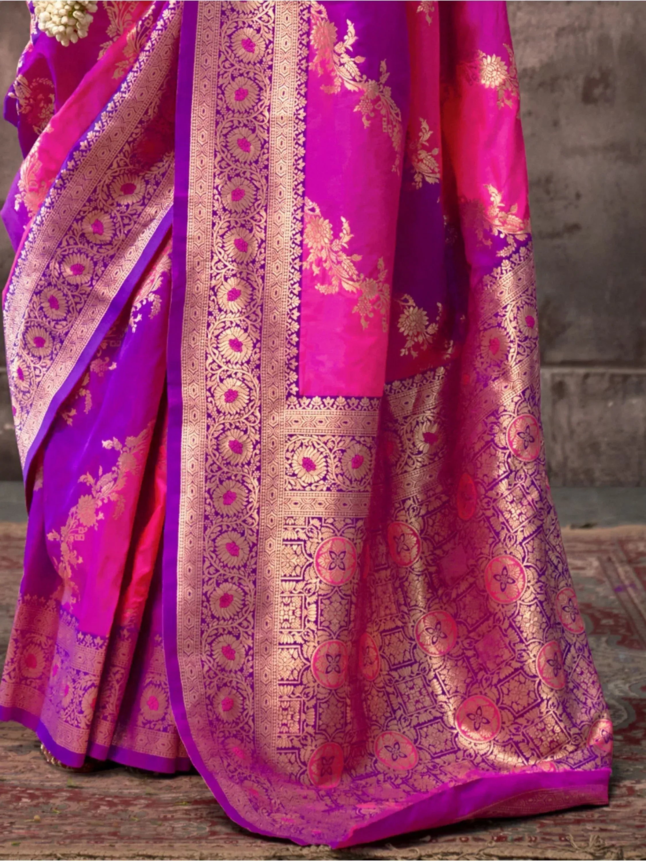 Vibrant pink and purple designer saree with intricate gold zari work, perfect for Indian ethnic occasions