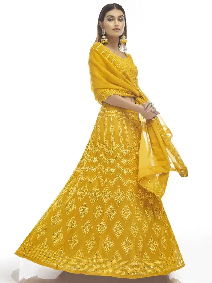 Yellow mirror work lehenga choli with geometric patterns, perfect for Indian ethnic wear occasions