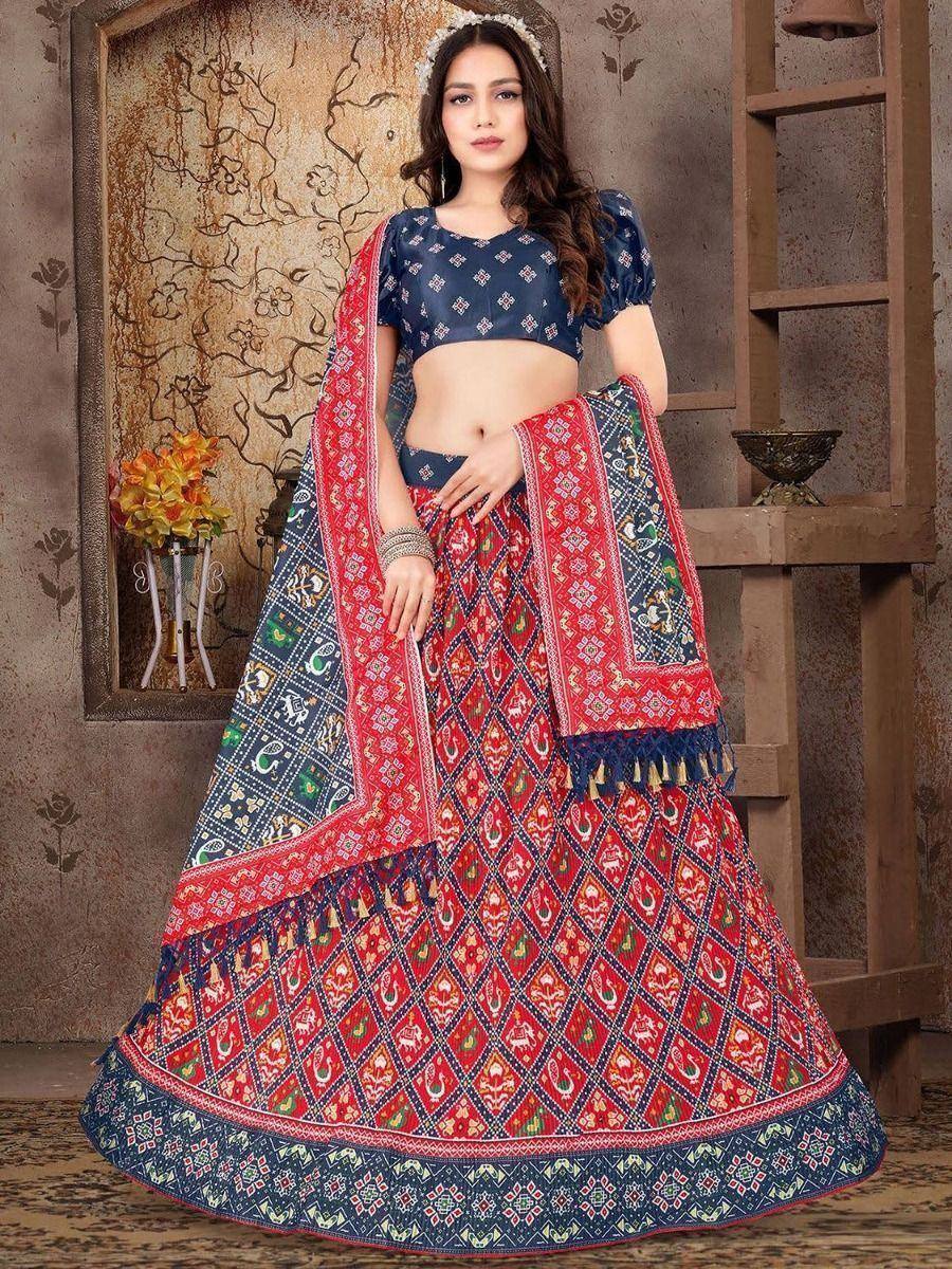 Red and blue printed lehenga choli with ethnic motifs, perfect for Indian weddings and festive occasions