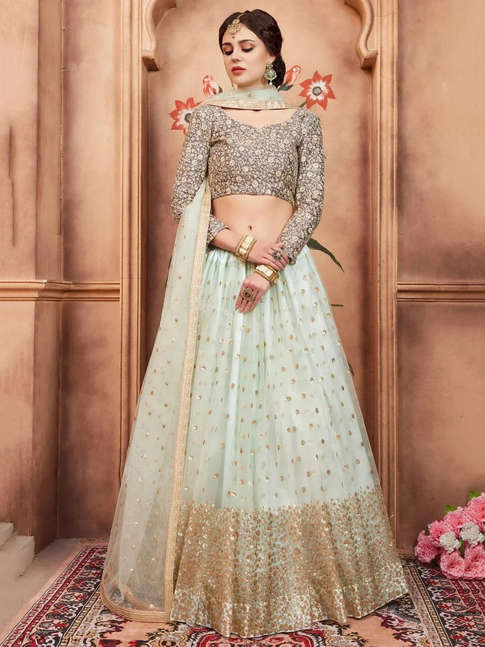 Mint green and gold embroidered lehenga choli with floral blouse, perfect for Indian weddings and festive occasions.