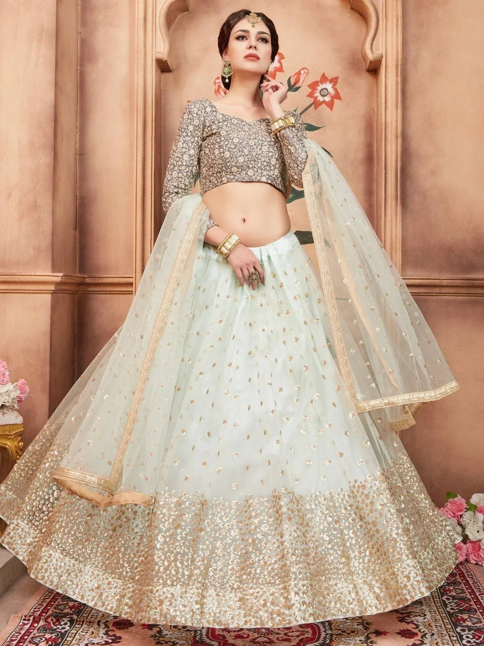 Mint green lehenga choli with gold embroidery, perfect for Indian weddings and festive occasions.