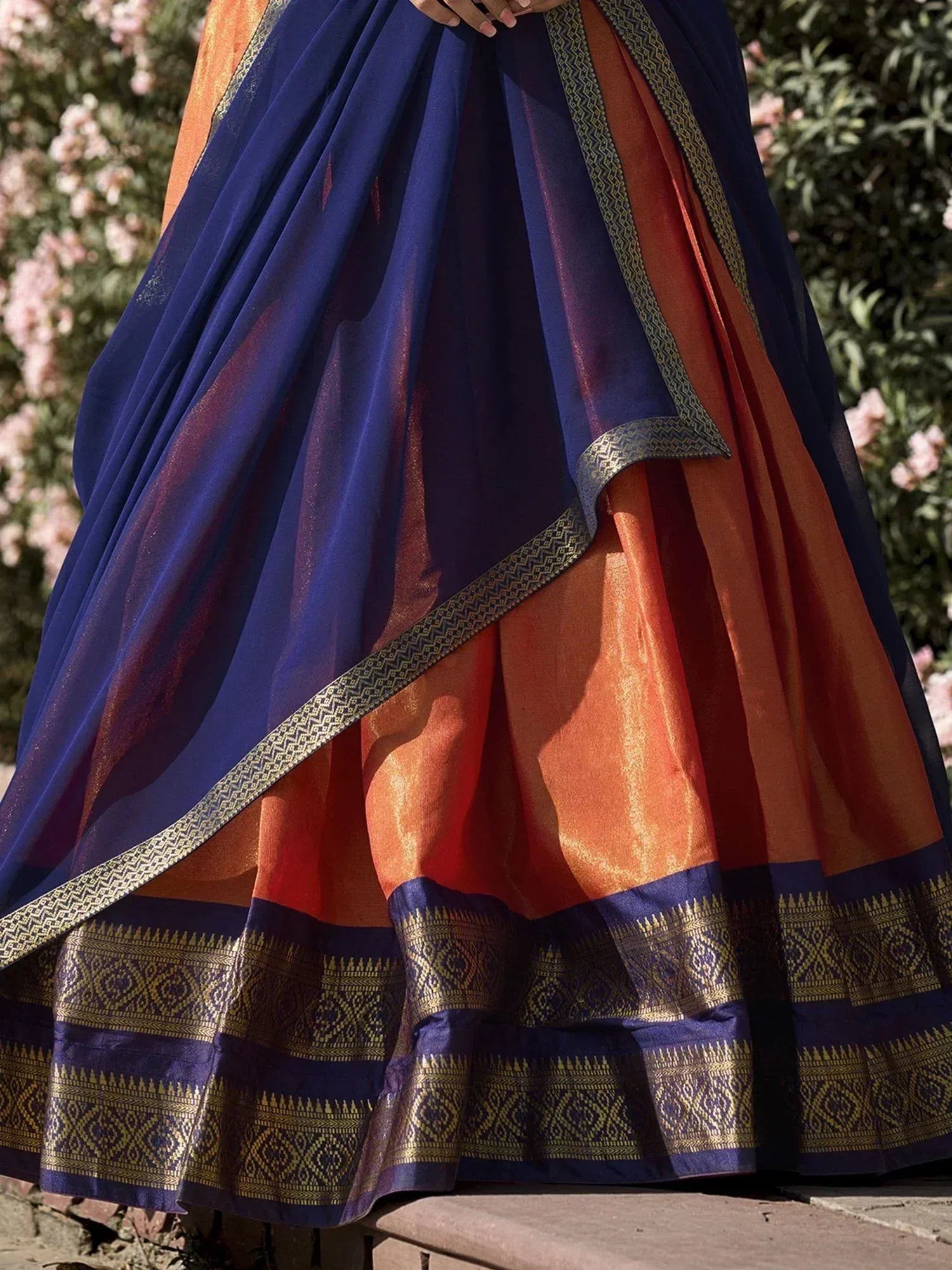 Navy blue and orange designer saree with gold border, perfect for ethnic occasions