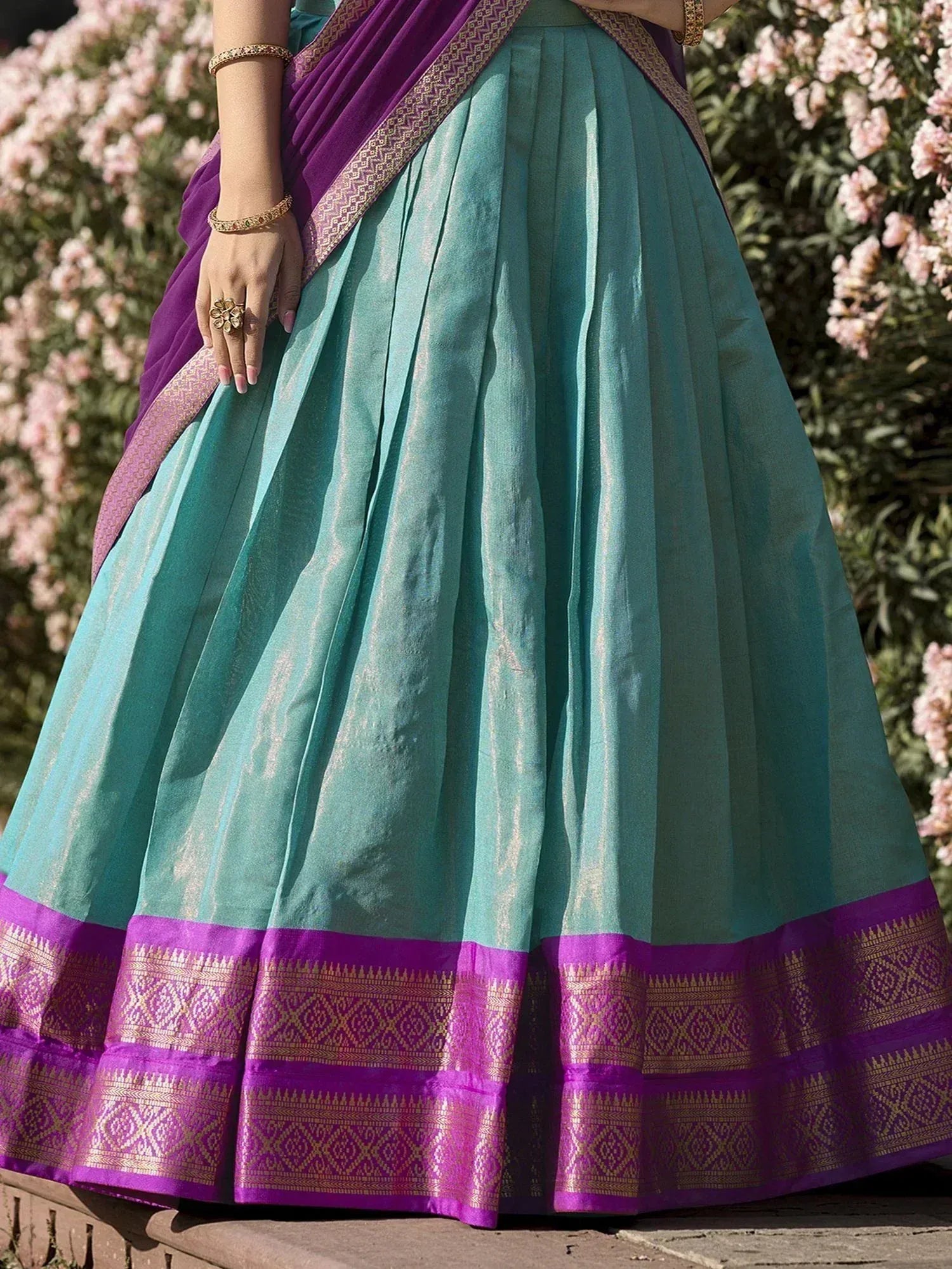 Teal and purple ethnic lehenga with gold border, perfect for Indian weddings and festive occasions