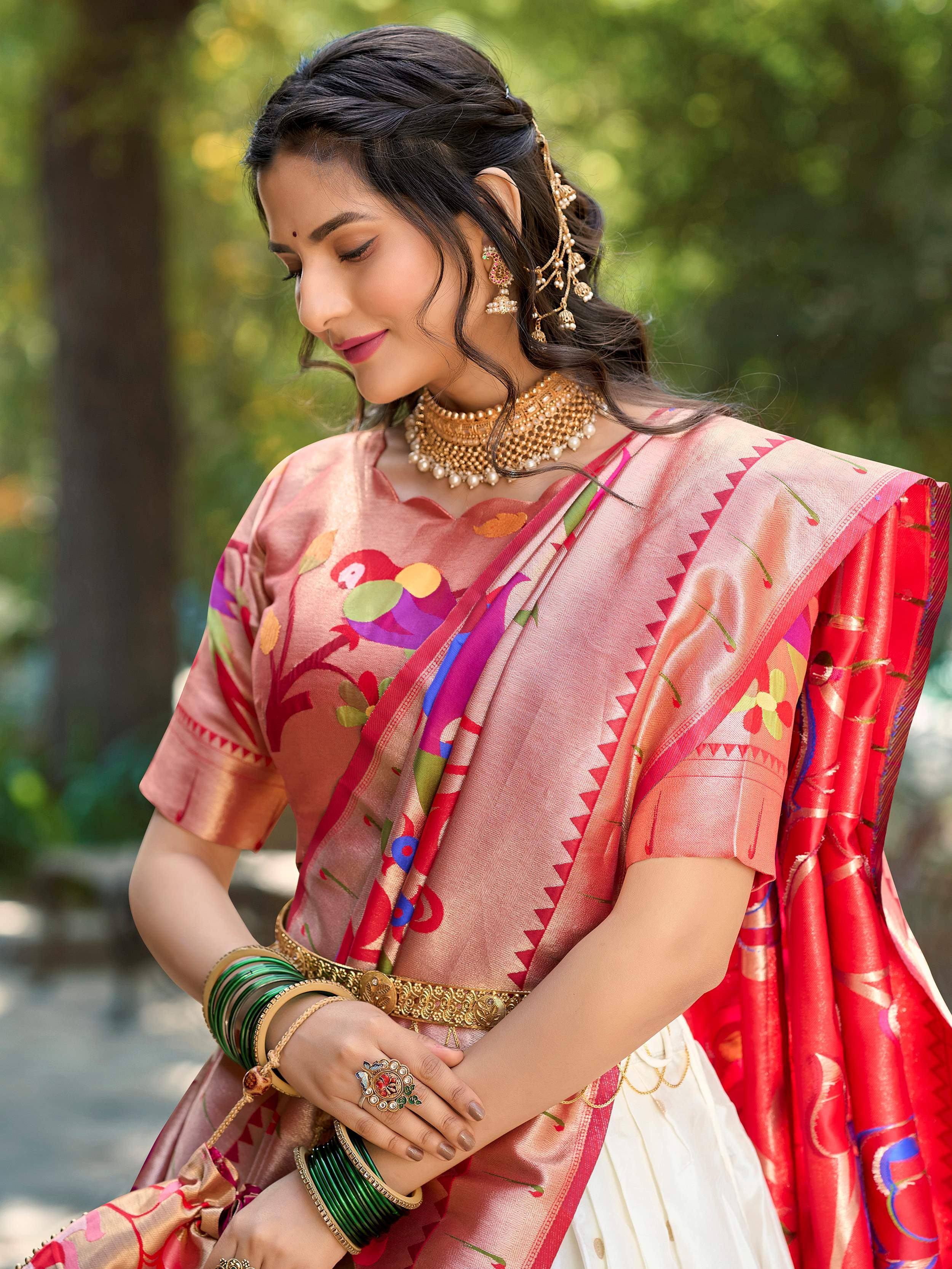 Woman in vibrant pink and red printed saree with gold jewelry, perfect for Indian ethnic occasions